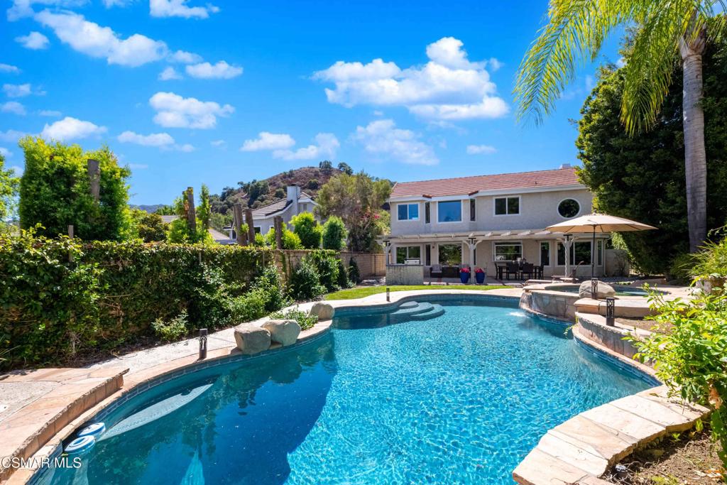 Welcome to 5676 Walnut Ridge Dr in the heart of Agoura Hills - a rare opportunity to own a luxurious and spacious entertainer's home with nearly 2,900 sq. ft. of living space, 5 bedrooms and 4 bathrooms, designed for comfort, style, and resort style living! Fabulous interior location in highly desirable Chateau Springs surrounded by gorgeous mountain views. Striking entryway with soaring cathedral-ceiling foyer that opens to a bright, airy, and spacious open floor plan. The main residence features a stunning remodeled kitchen complete with newer appliances, quartz countertops, cooking range with stone accent, breakfast bar and bay window that overlooks the sparkling pool and spa. Formal dining, family and living room, wine fridge, downstairs bedroom, full bath and laundry. Upstairs, the double-door entry primary suite offers the ultimate in luxury and comfort, with a sitting/entertaining area with custom bookshelves, en-suite bath, spacious closet. and pool and mountain views! Two additional upstairs bedrooms and hall bath provide flexible space for family or office needs. The fifth bedroom is a charming, detached in-law suite casita, complete with its own full bedroom and bath - perfect for guests, extended family, or possible rental income. A rare find indeed! The backyard is a resort-like tropical oasis, with a sparkling pool, spa, lush queen palms, patio and bbq for entertaining, landscaped privacy wall, and vibrant greenery. The charming courtyard and side yard at entry features mature mandarin and lemon trees, brick and stone accents, and a breezeway that creates a cozy, secluded vibe. Picture windows throughout the home invite the outdoors in, framing peek-a-boo mountain views. Newer roof, plenty of parking. Close to beaches, excellent schools, shopping, parks, entertainment and hiking trails. This highly unique property is rarely on the market ! Don't miss this chance to call Walnut Ridge your home!