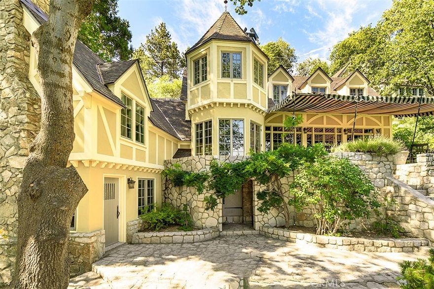 An Era Gone By... It is not often that one of Lake Arrowhead’s premiere and historic Lakefronts becomes available! This ‘Circa 1925’ Fairytale Stone Lakefront Cottage is its own private compound with stunning outdoor intimate spaces filled with glorious roses and shrubs and trees, assuring total privacy. There are glorious stone walls protecting its privacy and a meandering path leading down to the sparkling Lake Arrowhead Waterfront to the ‘Double Canopied Dock and Dock House.’ An electronic car gate allows for easy level entry to the Residence. There is a 4 Car Deep Garage with level access. The ‘North Shore’ is one of Lake Arrowheads premiere locations, as back over 90 years, these magnificent properties were sought by Hollywood Celebrities and famed Executives and this custom Stone Cottage has been noted as the ‘Bullock House’ and the probable Owner or Builder. The present Owners have impeccably restored and maintained the Residence for 30 years! Step into another world: 4 Bedrooms, 4 full Bathrooms and half Bath, Master Lounge has Fireplace and Office in the Main Residence. The Kitchen is modest and combines with circular Dining Area. Sweeping Staircase. Intimate Living Room with Fireplace. Dining area will seat 8 to 10 comfortably. Canopied Veranda! The property includes 2 separate Guest Apartments each with Fireplaces. The Upper features 2 Bedrooms, Bathroom and Full Kitchen / Lakeview. The Lower is a Suite with Fireplace and Bathroom. Gorgeous Lake Views from all points of the property. Walk to Tavern Bay Beach. Lake Arrowhead Mountain Resort is 1 1/2 hour drive from Los Angeles and Beach Cities.