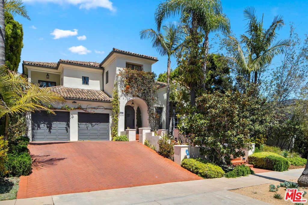 This beautifully renovated Spanish-style home seamlessly blends classic charm with modern luxury. Authentic architectural details are showcased throughout, from the soaring ceilings to the rich finishes. Step into the inviting living room, which opens to a serene front patio complete with a cozy fireplace perfect for relaxing or entertaining. The elegant dining room features gorgeous built-ins, creating a warm and refined atmosphere. The gourmet kitchen is a chef's dream, equipped with top-of-the-line appliances and connected to a spacious family room. French doors lead to a resort-like backyard oasis with a sparkling pool, ideal for California living. The main level includes a private en suite bedroom and a stylish library or home office, offering flexible living options. Upstairs, two additional en suite bedrooms provide comfort and privacy, while the luxurious primary suite is a true retreat. It features a fireplace, a separate sitting area, and access to a charming terrace. The spa-like primary bath boasts dual vanities, a soaking tub, a large shower, and a stunning built-in closet. A basement completes the home with a bonus room and an additional en suite bedroom perfect for guests or extended family. This home offers the perfect balance of sophistication, comfort, and style in a coveted location.