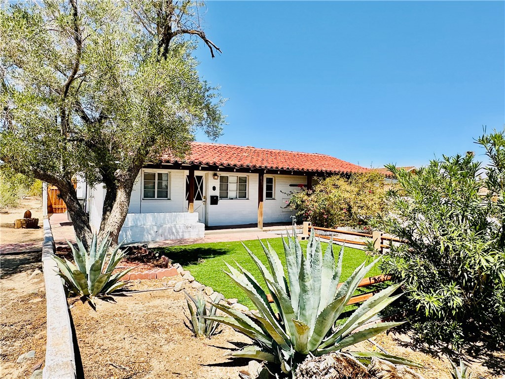 Truly unique, one-of-kind 1950’s Spanish style home situated minutes from the North Entrance of Joshua Tree National Park. Close to everyday conveniences - markets, shops, and neighborhood restaurants. Included in the sale is a neighboring lot with separate APN and unlimited potential. Build SECOND home right next door! Must see to appreciate, original home boasts so much character: vaulted wood ceilings, terra-cotta tile roof, observation deck, enclosed patio with Jacuzzi, original brick oven in the kitchen! You can keep looking, but you won’t find another one like this.