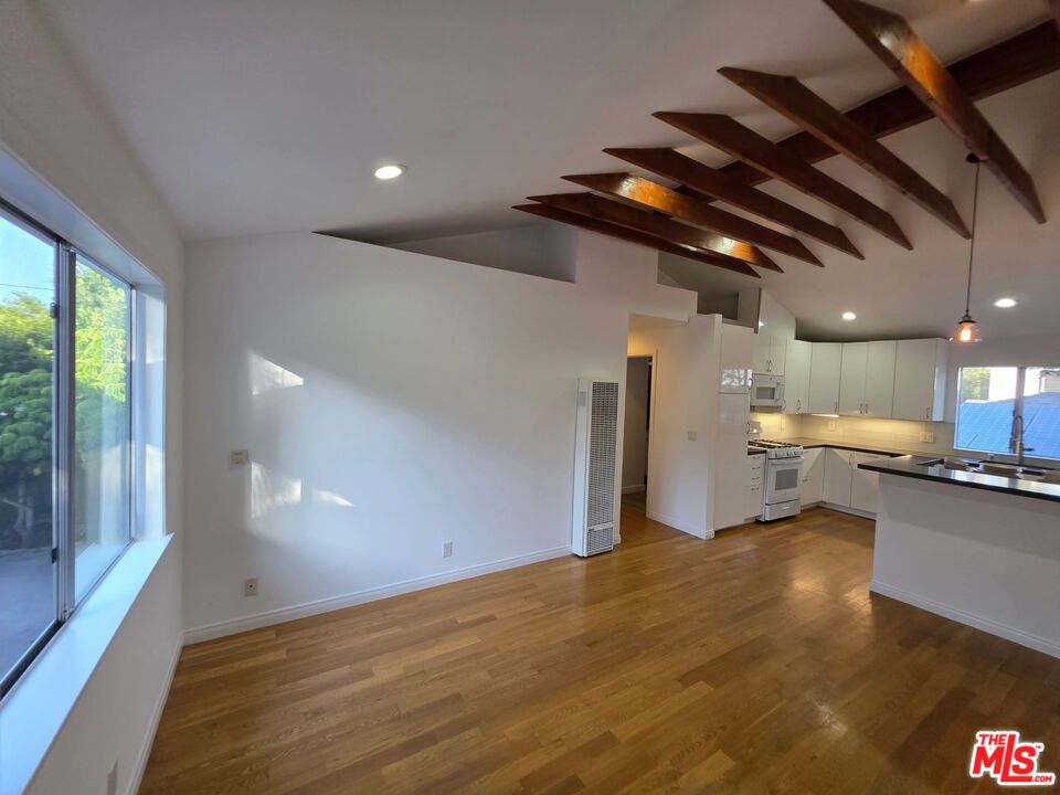 This beautiful Venice Apartment offers a bright and open layout with vaulted ceilings and wood flooring throughout. The heart of the home is a large, white chef's kitchen, complete with a refrigerator, gas stove, microwave, dishwasher, and ample cabinet space. The residence features three spacious bedrooms, each equipped with a ceiling fan, and two beautifully finished bathrooms with stylish details. A washer and dryer inside the unit adds everyday convenience. For parking, a large 2-car garage is available under a separate lease for just $10 per month for the first year. Located in the highly desirable Venice neighborhood, this home places you just minutes from Abbot Kinney Boulevard, local grocery stores, and all the dining, shopping, and coastal charm Venice has to offer.