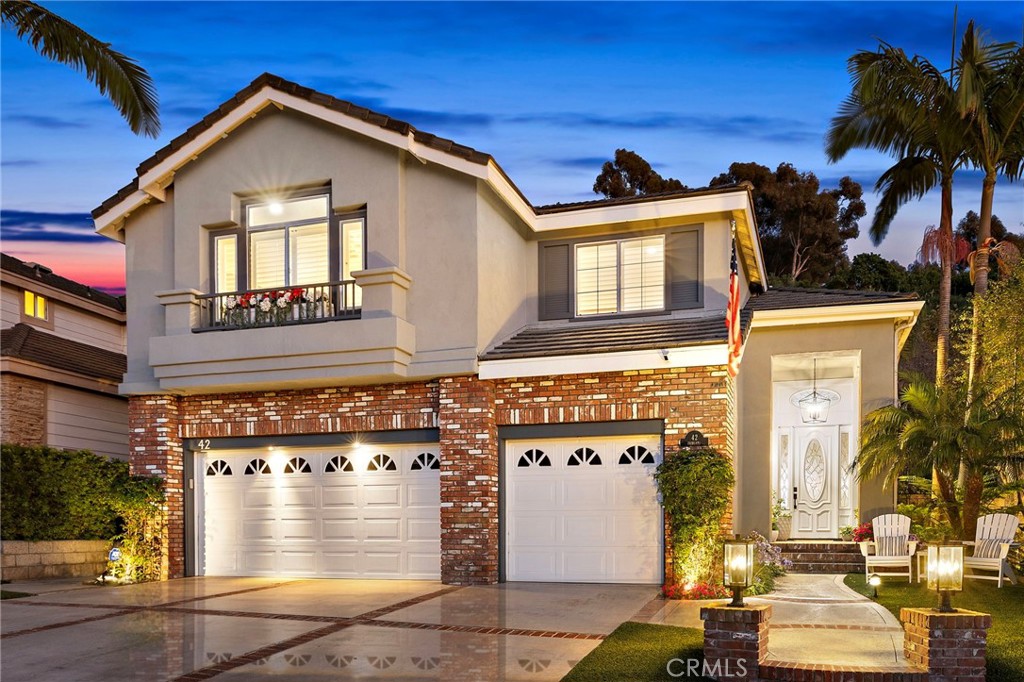 Welcome to 42 Fairlane, a beautifully remodeled residence in the sought-after gated community of Bear Brand Ridge. With over 2,700 square feet of living space, this 4-bedroom, 3-bathroom home offers a seamless blend of style, functionality, and comfort. Soaring ceilings and abundant natural light define the open floorplan, complemented by neutral tones, crown molding, wood flooring, and plantation shutters throughout. At the heart of the home is a stunning remodeled kitchen—featuring crisp white cabinetry, modern hardware, quartz countertops, and Viking stainless steel appliances—designed to inspire both everyday living and effortless entertaining. The adjacent oversized family room, complete with fireplace, built-ins, a Sub-Zero wine refrigerator (with capacity for up to 150 bottles), and a dry bar, flows seamlessly into the backyard oasis. Upstairs, the spacious primary retreat offers a second fireplace and a thoughtfully updated en-suite bath. Three additional bedrooms and a remodeled full bath complete the upper level. The backyard is both private and inviting, with lush landscaping, a built-in BBQ, outdoor fireplace, and spa—ideal for gatherings or peaceful evenings under the stars. A 3-car garage offers ample storage and convenience, and a new roof was installed just three years ago for added peace of mind. Located just minutes from top-rated schools, Ocean Ranch Plaza, scenic parks and trails, and the vibrant energy of downtown Dana Point and Doheny Beach, this move-in ready home delivers the best of Southern California living.