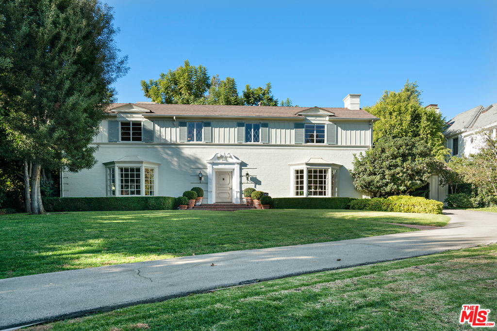 Enchanting 1936 Neo-Georgian Revival manor in prime Brentwood Park on flat .71 acre, north of Sunset Boulevard on west side of prestigious Bristol Avenue. Five beds + 5 baths. First floor: foyer w/curving staircase, living room w/FP, dining room, paneled library w/FP; garden room w/FP & bar overlooking gorgeous rear gardens. Breakfast room, kitchen, butler's pantry, laundry room, maid's ensuite, back hall & powder room. Second floor: primary ensuite w/dressing, bath & sitting room. Three additional bedrooms + 2 full baths. California basement. Gated & fully landscaped grounds incorporate lush lawns, large swimmer's pool, brick terraces, mature fruit trees & 3-car garage reached via porte cochere. Extraordinary architectural detailing & design. Well-maintained for past 61 years by present owner. Build an elegant new home or move-in now as the estate is warm, welcoming & clearly puts the "park" in desirable Brentwood Park!