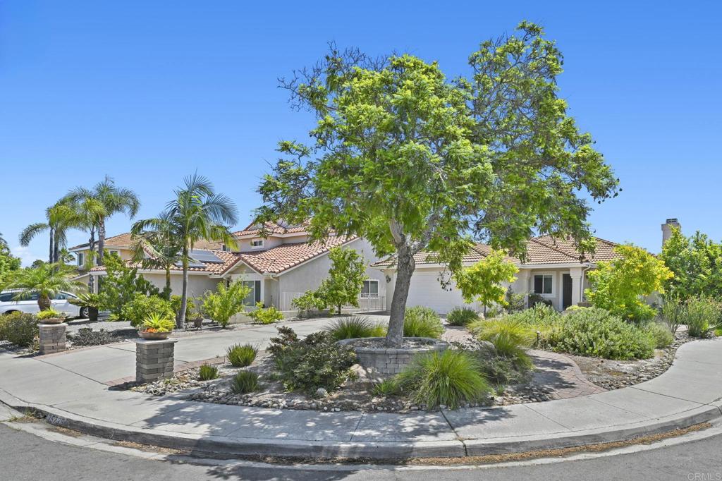 Nestled atop a serene cul-de-sac, this captivating single story gem delivers dazzling sunrise and breathtaking panoramic canyon views over rolling hills and evening lights. Thoughtfully upgraded with $100,000 in enhancements, this 4-bedroom, 2-bath home offers 1,760 sq ft of refined living space and exceptional curb appeal. Your journey begins in a beautifully reimagined front yard, featuring flowering trees and multiple paver pathways that lead to a charming courtyard. Step inside to an open-concept floor plan flooded with natural light, where renovated hardwood flooring flows seamlessly through the living room, family room, dining area, kitchen, and hallway. The remodeled, chef-inspired kitchen features a generous island, stainless steel appliances, gorgeous backsplash and designer finishes—perfect for both casual dining and entertaining. Enjoy your private backyard oasis framed by mature fruit trees and secured with a sleek glass fence with unobstructed panoramic views. Entertain in style in your covered patio with built-in island with outdoor grill and outdoor refrigerator. Elevate your golf game with a custom putting green, and unwind in the soothing hot tub while enjoying the night sky and evening lights. Additional upgrades include thoughtfully designed xeriscape landscaping, a luxurious bidet, whole house fan, an updated fireplace, and new Milgard windows. Smart and sustainable living is yours with owned solar and EV charging, delivering comfort and energy efficiency. Extended driveway parking for up to 6 cars plus 2-car garage. Enjoy access to community amenities such as a clubhouse, pool, spa, tennis courts, playground, BBQ area, and recreational spaces—perfect for active lifestyles and gatherings. Located in the award-winning Poway Unified School District and minutes to shopping, dining, and freeways, this home perfectly blends style, comfort, and convenience.