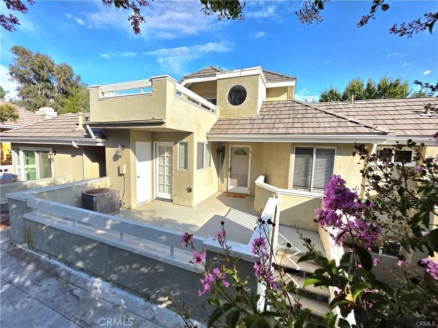 Don't miss out on this beautiful condo in the heart of Valencia for Lease! Located in the gated Arbor Park community this 2 Bedroom + 2 Bath + Loft upper-unit with three private decks—including one off the loft, another from the primary bedroom, and a third near the kitchen and entrance.  Over 1,200 sq ft of living space and featuring soaring cathedral ceilings and fireplace in the living area.  Upgraded kitchen with ample counter space and tons of cabinet storage, washer, dryer and refrigerator are included too. The primary suite offers a peaceful retreat with an en-suite bathroom, complete with dual vanities and walk-in shower and separate mirrored closets. The second bedroom is right off the kitchen and is close to the second remolded bathroom. Whether you're entertaining on the deck or relaxing in the peaceful surroundings, this property offers the perfect blend of modern comfort and lifestyle convenience. This unit includes a private one-car garage located below plus an additional covered carport space. Community amenities: pool, spa, gated access. Just minutes from the I-5 freeway, Valencia Town Center Mall, and across from convenient shopping and dining options makes this a property you must see.