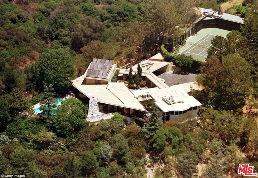 Perched atop a private 2.9-acre promontory with expansive views, this storied estate - once home to a Hollywood legend and originally designed by architect William S. Beckett - presents an incredible opportunity. With plans by Woods + Dangaran and Olson Kundig, this is a rare chance to restore one of Los Angeles' iconic architectural estates. A long, gated driveway winds through the property, revealing a multi-structure compound. The main house, reminiscent of Neutra and Lautner, boasts sweeping extended rooflines and walls of glass that frame panoramic views. The three-story creative studio/guest house offers a screening room, three guest bedrooms, a spa level with a gym, massage room, and sauna and expansive rooftop terraces that overlook the private tennis court. Beyond the estate, there is a private gate that lends access to the scenic trails of Franklin Canyon. This is your chance to restore this legendary pedigree property - plans available upon request.