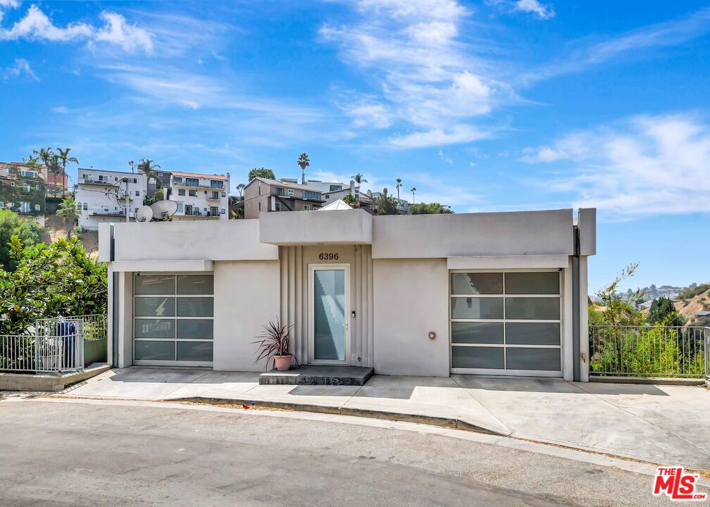 City lights and canyon serenity with amazing views, 6396 Weidlake has it all. A rare contemporary retreat in the exclusive Lake Hollywood enclave, this three-level residence is designed for both luxury living and unforgettable entertaining.Inside, newly refinished hardwood floors flow through an open-plan main level with a chef's kitchen featuring wood cabinetry, granite counters, and stainless steel appliances. The living room with fireplace, dining area, powder room, and direct garage access complete the heart of the home. On the middle level, three ensuite bedrooms include a spacious primary suite with fireplace, walk-in closet, and spa-style bath with amazing views.The entertainment level is a show-stopper, complete with a wet bar, flexible space for a home theater, media lounge, or game room, and access to an expansive view deck. With dual two-car garages, laundry room, and sunlit rooms throughout, this tranquil celebrity-favored location near Lake Hollywood offers both privacy and proximity to the best of Los Angeles.