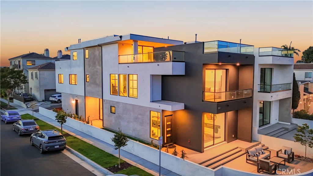 After overwhelming demand for its corner-lot counterpart at 201 Indianapolis, the opportunity has arrived to own the equally striking 203 Indianapolis Ave, now fully completed and ready for its first owner. Nestled just steps from the sand, Pacific City, and Main Street, this brand-new modern coastal residence delivers architectural brilliance, refined functionality, and a turnkey luxury lifestyle in the heart of Huntington Beach.
Spanning three levels with a private elevator and an expansive rooftop deck, the home is designed for seamless indoor-outdoor living with walls of glass, Fleetwood-style doors, and multiple outdoor retreats capturing natural light and ocean breezes. The open-concept main floor showcases a chef’s kitchen with custom cabinetry, high-end appliances, and a statement island that flows effortlessly into the living and dining spaces.
The primary suite offers a spa-inspired bath, walk-in closet, and private balcony, while secondary bedrooms provide flexibility for guests, an office, or fitness space. Every detail—from custom finishes to thoughtful floor plan design—has been curated to elevate modern coastal living.
With its Certificate of Occupancy secured, 203 Indianapolis is move-in ready, offering the rare chance to own new construction luxury in Surf City. Whether entertaining on the rooftop deck, enjoying sunset strolls to the beach, or dining at world-class restaurants just minutes away, this home is the perfect blend of style, comfort, and location.
Don’t miss your chance to make 203 Indianapolis your own—the sequel to Huntington Beach’s most talked-about new build.
Interior images depict 201 Indianapolis, a staged corner lot model. 203 Indianapolis is the same new construction design but is currently unfurnished.”
