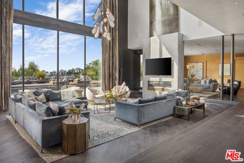 Priced to sell! Private gated home of John Legend and Chrissy Teigen, one of the worlds most stylish celebrity couples. The grandeur begins in the parlor,w/ its 33-foot ceilings and sculptural staircase, & continues in the extraordinary living room, where floor-to-ceiling windows offer sweeping canyon views. Bespoke patterned ceilings from Thailand, cerused oak floors and clay & steel-rolled walls exude sensuality. The chef's kitchen befits a culinary influencer opens onto a large family room. The master bedroom features a brass & concrete fireplace, a balcony, a lush Glam Room, & exquisite, newly designed closets evocative of a Chanel showroom. A marbleTeuco tub, onyx sinks & a double shower are the stars of the master bath. The design language continues in the backyard, with its heated saltwater pool and jacuzzi, woodburning oven, chef's grill, & grapevine-wrapped pergola. Solar power and 70kW generator complete the estate. Only moments to The Beverly Hills Hotel and Rodeo Drive.
