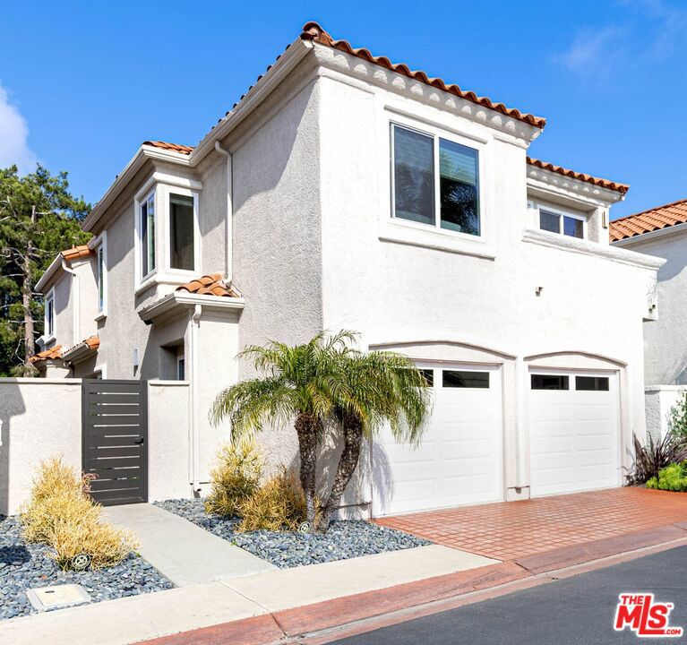 Experience the ultimate in coastal sophistication at 28 Saint Kitts, a beautifully upgraded residence in the coveted, guard-gated community of Antigua within Monarch Beach. This detached 3-bedroom, 2.5-bath home with a 2-car garage enjoys peek ocean views and embodies timeless elegance with a fresh, contemporary coastal aesthetic. Every inch of the home has been thoughtfully reimagined to reflect refined design and effortless livability. The stunning remodeled kitchen features custom navy cabinetry contrasted with Calacatta Trevi quartz countertops and a shell-blue agate-style tile backsplash creating an artful statement that balances beauty and functionality. A generous island with seating anchors the space, perfect for gathering. The living room provides a welcoming centerpiece with soaring two-story ceilings, focal point fire and ice gas fireplace completely bathed in natural light. The chic powder room downstairs offers a wall-mounted sink and sculptural pendant lighting, blending artistry with practicality. Downstairs flooring is finished in timeless, durable travertine tile, transitioning upstairs to wide-plank luxury vinyl flooring both beach and pet-friendly for easy coastal living. Custom flat panel interior doors with privacy glass add a serene, modern touch that allows soft light to filter throughout the home. Upstairs, the spacious primary suite is a true retreat with a private balcony overlooking a lush green hillside with no neighbors behind. The spa-like primary bath features a large soaking tub framed by a view-filled window, a sleek contemporary vanity, separate shower, and a custom California Closets walk-in that makes getting ready feel like a boutique experience. There are two nice sized bedrooms upstairs with a shared balcony with peek ocean views. The upstairs hall bath has also been completely remodeled with today's coastal style in mind. The 2-car attached garage with direct access features high-performacee epoxy flooring offering a clean contemporary aesthetic transforming the garage into a luxury showroom for your car or favorite beach toys. This exceptional home is ideally situated just moments from Salt Creek Beach, Dana Point Harbor, The Montage, The Ritz-Carlton, and the Monarch Beach Tennis Club placing you at the center of Southern California's most coveted coastal experiences. Here, you're not just purchasing a home, you're embracing a lifestyle where every day feels like a vacation. Whether you're seeking a serene full-time residence, a second home, or a weekend escape, 28 Saint Kitts offers low-maintenance luxury in one of Orange County's most desirable beachside enclaves. Don't miss the opportunity to enjoy this turnkey coastal haven just in time for summer!