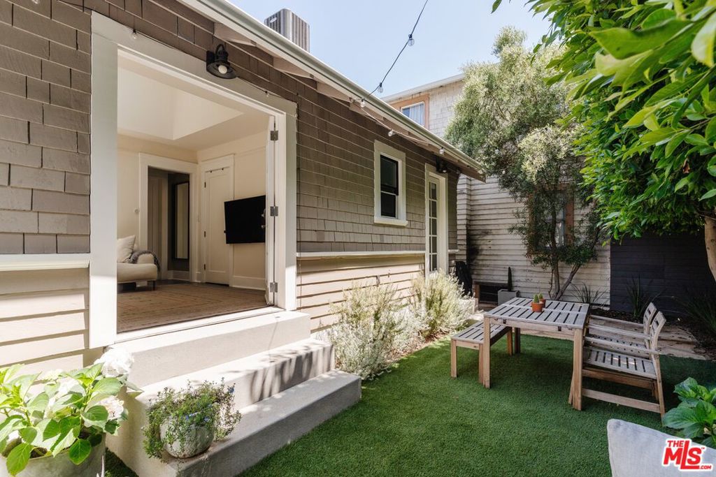 Experience effortless coastal charm just steps from Abbot Kinney and the beach at this curated Venice Beach bungalow with timeless character with high-end finishes. This curated home offers 2 bedrooms, 1 bathroom, and 1,072 SF of living space on a 1,528 SF lot, showcasing classic craftsmanship throughout and a private backyard oasis perfect for relaxing and entertaining guests. An inviting front deck welcomes you to the home and opens up to a bright, thoughtfully designed interior featuring oak hardwood floors, tongue-and-groove coffered ceilings, and extensive wainscoting. The gourmet kitchen boasts custom cabinetry, marble countertops, and top-of-the-line stainless steel appliances. A well-appointed mudroom adds function and charm with built-in storage, while chic lighting and curated fixtures elevate the entire space. The primary bedroom features skylights and French doors opening to the private sunlit backyard, ideal for relaxing after a day at the beach. A newly remodeled bath with a wide-tile floor and bespoke vanity complete the interior. Upstairs, you'll find additional storage and a spacious second bedroom that also functions as a bonus flex space great for a home office, guest room, or creative studio. With dedicated space for bikes and boards and quick access to the beach, farmers markets, Main Street, and Abbot Kinney, this refined beach bungalow offers idyllic laid-back coastal living in the heart of Venice.