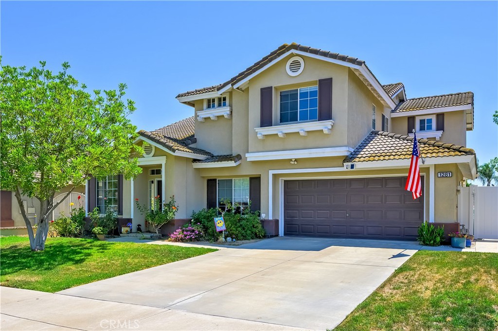 Welcome to this beautifully updated 5-bedroom, 3-bath home in the heart of Corona! With 2,394 square feet of living space on a 7,405 square foot lot, this home is designed for both comfort and style. Featuring renovated flooring, a modern kitchen, and updated bathrooms, this home is move-in ready and reflects pride of ownership throughout. The first floor includes a spacious bedroom and a full bathroom, perfect for guests or multi-generational living. A separate laundry room leads to the 3-car tandem garage for added convenience. Upstairs, you'll find four more bedrooms, including a master suite with a massive walk-in closet and an en-suite bathroom featuring a separate tub and shower, as well as a private toilet room. The well-groomed backyard offers a covered patio, ideal for outdoor entertaining. Additional features include central HVAC, LVP flooring throughout, a gas fireplace in the living room, and a new vinyl fence surrounding the backyard. Located just minutes from the 15 and 91 freeways, including the 91 toll lanes for easy access to Orange County, this home is perfectly positioned for a quick commute. With parks, shopping centers, and dining options just around the corner, you'll have everything you need within reach. Don’t miss out on this opportunity to own a spacious, updated home in a fantastic location!