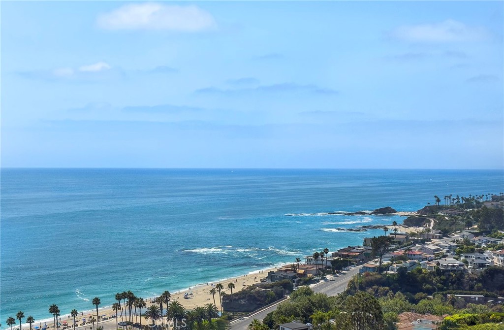 Perched on a prime lot in the prestigious COAST ROYALE area of South Laguna Beach, this coastal gem boasts breathtaking ocean views including whitewater, Catalina Island to Palos Verdes, and sandy beach/coastline views. The 7500 square foot lot spotlights spacious and serene patio areas designed to enjoy the view and to entertain while capturing the spectacular endless ocean and sunset views. The upper level features an open designed kitchen/family room and dining room area complete with walk-in pantry, an office alcove and the primary bedroom suite...all with panoramic ocean views and all with doors opening to a large view deck and to secluded patio areas. The main entry, on the lower level, includes a living room with cozy fireplace and library nook and amazing ocean views, a main floor bedroom which opens to a lovely view patio, a secondary bath and inside laundry room. The property includes a one car carport, flagstone steps and patio areas. This delightful property includes wood plank flooring, open beam ceilings, newer Tankless hot water heater, sound/media system, stainless steel Gaggenau gas cooktop and two ovens plus commercial style Subzero refrigerator, newer white cabinetry and a farmhouse sink. This fun BEACH HOUSE property offers one of the best views in Laguna Beach while nestled in a natural seaside setting. Live your dream beach life in this coastal retreat providing stunning ocean views, charm and tranquility.