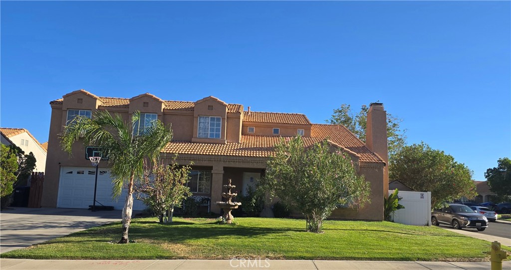 Beautiful, Comfortable, and Private Two Story Corner Lot Home. This Corner Lot only shares one side with neighbors creating a very private feel. Yet you can still enjoy easy access to open paths and the activity trails of this desirable neighborhood all the while staying close to many great amenities, such as convenient stores, restaurants, grocery stores, the Palmdale Mall, etc., merely 5 minutes from your front door.
A kitchen is the heart of a home and this kitchen is light and bright with plentiful counterspace and stainless steel appliances. The adjacent dining room and 2 living rooms flow to create a seamless and open living space and also you can enjoy a private office space in the first floor. This house has a spacious master bedroom with its own dedicated full bathroom and a nice balcony to enjoy the sunsets and beautiful nights. This home has three other comfortable bedrooms, each one with their own roomy closets. Interior design features include vaulted ceilings, built-in cabinetry and a fireplace in one of the living rooms. Some updates and upgrades include new multi-zone central heating and air conditioning and an additional newly installed swamp cooler, new tankless water heater, and EV charging all to save money on energy and rising fuel costs.
The outdoor space includes charming areas with a built-in barbecue, a fire pit, and an outdoor dining area perfect for al fresco entertaining amid the fruit trees, mature landscaping and lush greenspace. Enjoy the bounty of your new fruit trees such as oranges, apples, and figs. Or retreat to your man cave or music studio for a jam session or karaoke with friends or some quiet time on your hobby or project.