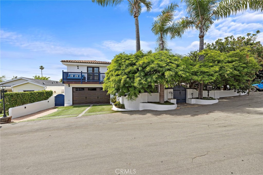 Discover this enchanting storybook cottage nestled on a corner lot in the sought-after Woods Cove of Laguna Beach. Framed by graceful shade trees and towering palms, the property welcomes you with a gated flagstone patio leading to an entertainer's haven featuring a charming gazebo and expansive side yard. This Beach cottage comprises 3 bedrooms and 2.5 baths, exuding warmth with its vintage details, vaulted wood ceilings, exposed beams, and stained glass accents.
The living room boasts high ceilings, a cozy fireplace, while the open kitchen is equipped with butcher block counters, a farmhouse sink, and a breakfast bar. The primary suite upstairs offers a serene retreat with a deck showcasing ocean views, accompanied by an additional bedroom that can serve as an office space. The main level hosts the third bedroom with an ensuite bath, a powder room, and private rear deck.
Enjoy in the private wraparound yard that blends indoor and outdoor living with lush landscaping and covered patios, perfect for year-round enjoyment. Just blocks from Laguna’s pristine beaches and the vibrant HIP district, this home offers an unparalleled coastal lifestyle.