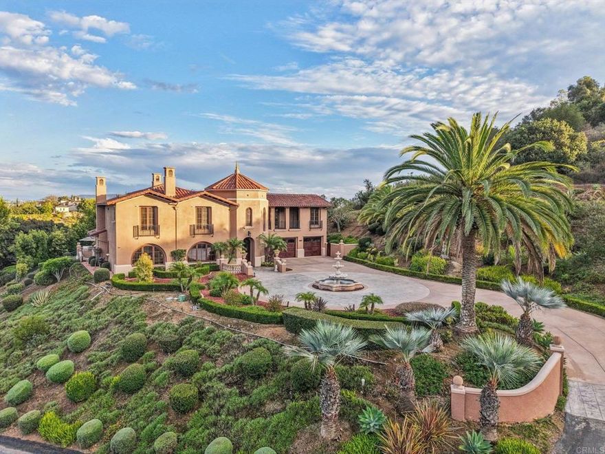 This private Mediterranean estate is set on an elevated 1.13-acre lot with sweeping mountain views at the end of a cul-de-sac in the prestigious guard-gated Cielo community within the highly sought-after R Roger Rowe School boundaries. Main residence offers 5 bedrooms, 3.5 baths, theater room, office, upstairs bonus room, along with an attached ADU that has a bedroom and bath. Grand driveway ascends to a circular motor court, where a meticulously landscaped yard and stunning fountain create a dramatic stage for arrival. Soaring two-story foyer with hardwood floors and a sweeping staircase welcome you. Formal living room has a fireplace framed by arched doorways, while the neighboring office is finished with custom built-ins. Kitchen features white cabinetry, a large center island, premium appliances, and daily dining that flows seamlessly into the family room with fireplace. Formal dining room and powder room complete the main level. Upstairs, primary suite offers a fireplace with raised hearth, private balcony, a spa-inspired bath with dual vanities, soaking tub, walk-in shower, and an expansive walk-in closet. Three additional bedrooms,  2-baths, laundry room, and bonus room complete the main residence. Attached ADU has a private entrance, full kitchen, living room, bedroom, and bath. Backyard is designed for entertaining with an oversized spa and cascading water feature, built-in BBQ island, fireplace, pergola, and multiple seating areas all surrounded by lush landscaping and mountain views. Entertainment continues with a private theater with separate exterior access. Additional highlights include 10KW owned solar system, 3-car garage, 2 tankless water heaters, EV charger, and wired for sound in select areas of the home with built-in speakers. Enjoy 24-hour guard-gated security, resort style amenities including a clubhouse, fitness center, pool, spa, tennis courts, pickleball, volleyball, basketball, & playgrounds.
