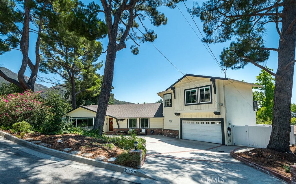 Nestled in the supremely serene Briggs Terrace neighborhood of La Crescenta on a cul-de-sac street, this spacious pool home offers the perfect blend of comfort, style, and beautiful views. Enjoy both majestic mountain vistas and sparkling city lights from multiple vantage points. The backyard oasis is ideal for entertaining, complete with a sparkling pool, generous patio space, and excellent privacy. Inside, the flexible floor plan includes two distinct living spaces – a formal living room and a family room that flows seamlessly into the dining area and updated kitchen, with sliding glass doors that open to the backyard. The kitchen is both beautiful and functional, featuring a dedicated prep area, a center island, newer appliances, updated countertops, and windows overlooking the backyard. Upstairs, the primary retreat is a true getaway with its own attached bathroom, a private office or fifth bedroom, and a balcony showcasing gorgeous views. Located within the highly regarded Mountain Avenue Elementary boundary, this home has seen extensive updates over the past few years, including new plumbing, electrical, windows, floors, pool equipment, downstairs heating and air, interior and exterior paint, a whole-house water filtration and softening system, EV charger, security system, gutters, and sprinkler system. The home also includes a separate laundry area, lots of storage, and a large driveway with an attached 2-car garage. This is a rare opportunity to own a large, updated home for this price in one of La Crescenta’s most peaceful neighborhoods, offering both modern comforts and timeless appeal.