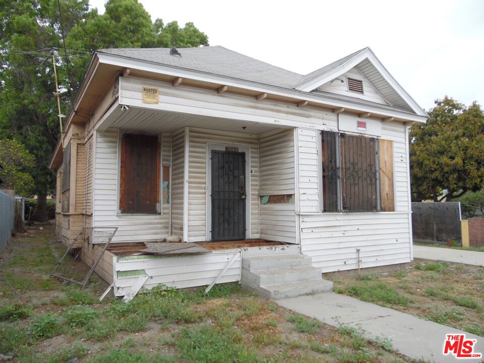INVESTOR DELIGHT! 1920s California Bungalow on a deep, gated lot offers serious upside for a savvy builder or flipper. Interior is gutted with lath-and-plaster exposed, missing porch decking, and no functional kitchen or bathroom. Ideal blank canvas to reimagine modern floor-plan/ADU potential (buyer to verify zoning & permits). Long driveway accommodates multiple cars, work trucks or an RV, and the expansive rear yard is dotted with mature shade trees. Minutes to Earvin "Magic" Johnson Park, Metro A-Line, Watts Towers Arts Center, 105 & 110 fwys, local schools, and everyday shopping. Probate sale. sold strictly AS-IS; Bring your contractor and unlock the value!