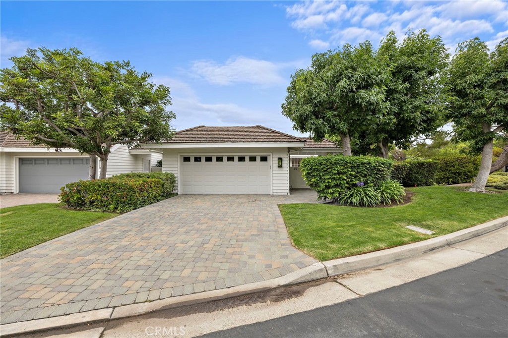 Live just steps from the ocean in one of Newport Beach's most prestigious communities. Presenting 49 Southampton court within the gates of Belcourt Hill. This corner lot condominium is completely turn key highlighted by updated kitchen, bathrooms, and living spaces. Enter through a cozy enclosed private courtyard to reach the open main living space. The main floor features vaulted ceilings and skylights providing for exceptional sunlight and a spacious feel. The remodeled kitchen, featuring an island and upgraded appliances opens to a formal dining room - both adjacent to an expansive deck catching the ocean breeze. Additionally an added bathroom on the main floor allows the bonus flex space to be used as an extra bedroom or office. The lower floor houses two main bedrooms with upgraded bathrooms and finishes. The master suite with fireplace, beautiful master bath including a vessel tub, large walk-in shower, and walk-in closet with built-in closet organizers leads out to a second deck positioned in front of serene greenery. With an open floorplan and sophisticated architecture this turn key residence gives an expansive and luxurious feel throughout. Additional features include a washer/dryer, A/C, central heating, 2 gas fireplaces, oversized 2 car garage, and large driveway for added parking.