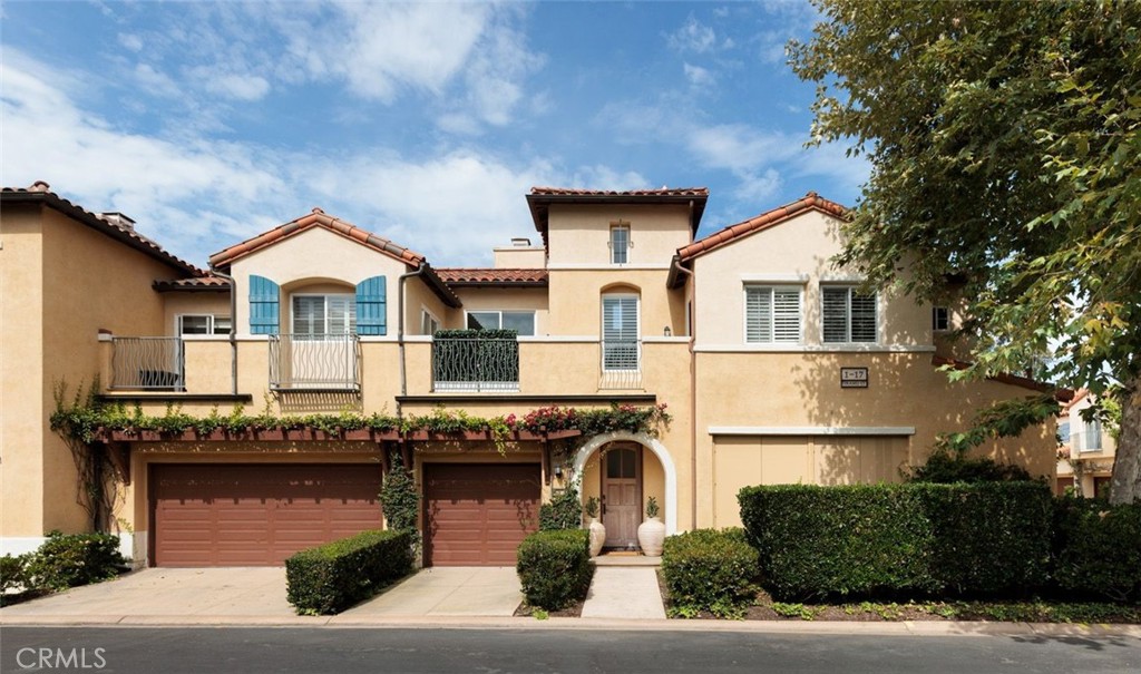 Welcome to 2 Teramo Ct. a professionally curated and extensively upgraded corner unit located in the exclusive gated community of Trovare in Newport Coast. Designed by an interior designer, this 2-bed, 2-bath home spans approx.1,326 sqft. and offers a seamless blend of coastal elegance and modern comfort. The open-concept layout is enhanced by vaulted ceilings, custom wood beams, rich lacquered moldings, and abundant natural light. The gourmet kitchen features white cabinetry, quartz countertops, subway tile backsplash, stainless steel appliances, and flows into a spacious living and dining area with a fireplace and direct access to a private deck, ideal for al fresco dining or relaxed entertaining. Every inch has been thoughtfully upgraded. All recessed lighting has been replaced with high-efficiency 3000K LED fixtures, and every switch, outlet, and dimmer has been modernized for optimal lighting control. The living and dining areas showcase bespoke built-ins with added storage and quartz shelving, while the fireplace wall features black absolute granite surround, a wood-paneled mantle, lacquered cabinetry, and elegant shelving—creating a striking focal point. The primary suite offers a customized walk-in closet, sliding door entry, and access to the upstairs deck via a new insulated glass door. The en-suite bathroom includes new recessed lighting, updated fixtures, quartz countertops, new sinks and faucets, and custom-framed mirrors that extend to the ceiling. The separate toilet room features a space-saving sliding door. The secondary bathroom has been remodeled with large-format porcelain tile, a new quartz vanity top, oversized mirror, updated lighting, and modern fixtures. In the second bedroom, a tray ceiling with detailed molding and recessed lighting adds architectural interest. Additional upgrades include new custom white vent covers, oversized chrome door levers and hinges, updated cabinet hardware, a new GE dishwasher, garbage disposal, and a custom gas fireplace log set. The oversized 2-car garage features a new epoxy floor and built-in cabinetry for optimal storage. Residents of Trovare enjoy exclusive access to resort-style amenities, including a saltwater pool, spa, tennis and pickleball courts, clubhouse, and manicured greenbelts. Ideally located near Crystal Cove, Pelican Hill, Fashion Island, and Newport’s world-renowned beaches and dining, this turnkey home offers thoughtful customization, designer elegance, and elevated coastal living.