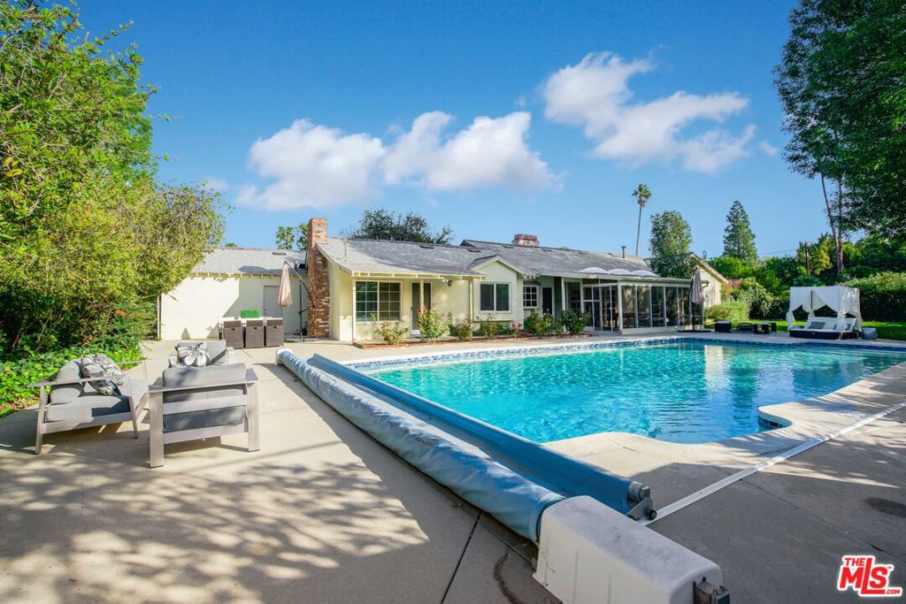 FULLY FURNISHED AND FULLY EQUIPPED This 4-bedroom and 3.5-bathroom with a bonus room with sofa and desk 2,256 square foot bohemian home in Woodland Hills, California. Nestled in the Walnut Acre neighborhood close to Malibu and Universal Studios, your favorite theme park and the beach will always be close by when you desire to have a day out in the California sunshine. A 17,000 square-foot lot, this property comes with a spacious patio, an Olympic pool, a large side yard, and spacious sunroom with skylights that overlooks beautiful nature and greenery. This home delivers the perfect amount of luxury and serenity for both long-term and short-term stays, especially with room for 2 to 3 cars! The master bedroom features a king-sized bed, a custom walk-in closet, and a luxurious ensuite bathroom with a large shower. Open the blinds and natural light will bring the space to life, flowing from the living room into the kitchen and dining room. If living space isn't enough, work in a bonus room with a desk, making work from home a breeze. Nestled in a cul-de-sac in Walnut Acres, this home delivers a relaxing residential experience. Enjoy evening movie nights with smart TVs in every room or game nights in the sunroom with foosball, air hockey, and ping pong tables. Better yet, cook up 5-star meals in a white and bright kitchen that offers high-end stainless-steel appliances, wood cabinets, double wall ovens, and a modern gas cooktop. No matter the occasion, this bohemian inspired home is yours for the taking, so pack a bag and come experience what Woodland Hills has to offer. Price reflects year lease please inquiry for short term.