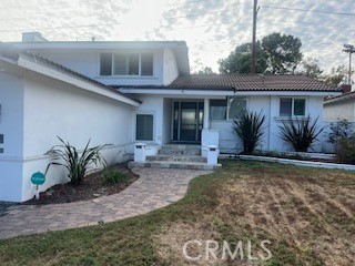 STUNNING, ENTERTAINER'S DREAM HOME!! This home is absolutely move-in ready home. This home brings in a ton of natural light, it is a refreshingly fully renovated and family friendly home in well-located and maintained Cerritos. This 5-bedroom 3-bath home is facing east. The floor plan is an open, easy flowing home. Living room, dining room, kitchen dining area, and family room are each elegantly, uniquely and tastefully decorated. This home is immaculate! Spacious living room with cozy fireplace, and formal dining room that opens to an inviting outdoor open patio, BBQ grill, fire pit, outdoor fryer, built-in outdoor kitchen and large pool - 4' to 8' deep. Step down into a separate family room, where two bedrooms, laundry room and bathroom with shower are located (ideal for guests or share this home with family). The open kitchen includes upgrades - from porcelain countertops, floors, new kitchen appliances, gas top range, range hood and dishwasher; custom cabinetry, countertops in fully renovated kitchen and bathrooms, updated vanities, appealing fresh paint throughout, wood floors, tile floors, and modern manufactured quality vinyl wood-like floors. This home includes new windows, copper plumbing, streamlined, efficient recessed lighting throughout the house. Direct access to the large 2 car garage. Custom wood shutters, new HVAC, spa tub in master bathroom. 2 bedrooms downstairs and 3 bedrooms upstairs. Walking distance to Liberty Park, Los Cerritos Mall, and located in the award-winning ABC school district. This home is a MUST SEE!!