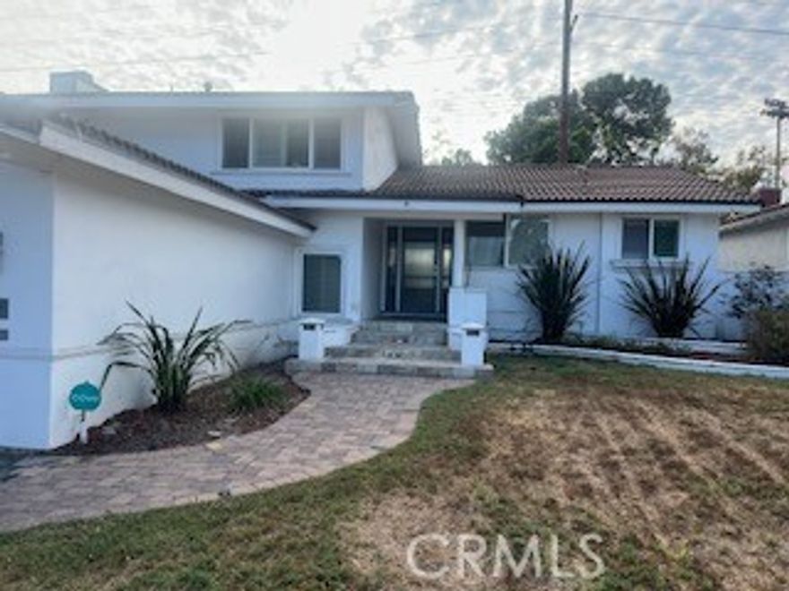 STUNNING, ENTERTAINER'S DREAM HOME!!  This home is absolutely move-in ready home.  This home brings in a ton of natural light, it is a refreshingly fully renovated and family friendly home in well-located and maintained Cerritos. This 5-bedroom 3-bath home is facing east.  The floor plan is an open, easy flowing home.  Living room, dining room, kitchen dining area, and family room are each elegantly, uniquely and tastefully decorated.  This home is immaculate!  Spacious living room with cozy fireplace, and formal dining room that opens to an inviting outdoor open patio, BBQ grill, fire pit, outdoor fryer, built-in outdoor kitchen and large pool - 4' to 8' deep. Step down into a separate family room, where two bedrooms, laundry room and bathroom with shower are located (ideal for guests or share this home with family).  The open kitchen includes upgrades - from porcelain countertops, floors, new kitchen appliances, gas top range, range hood and dishwasher; custom cabinetry, countertops in fully renovated kitchen and bathrooms, updated vanities, appealing fresh paint throughout, wood floors, tile floors, and modern manufactured quality vinyl wood-like floors.  This home includes new windows, copper plumbing, streamlined, efficient recessed lighting throughout the house.  Direct access to the large 2 car garage.  Custom wood shutters, new HVAC, spa tub in master bathroom.  2 bedrooms downstairs and 3 bedrooms upstairs.  Walking distance to Liberty Park, Los Cerritos Mall, and located in the award-winning ABC school district.  This home is a MUST SEE!!