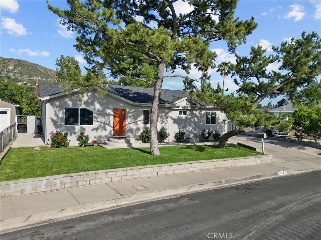 Welcome to the epitome of modern luxury in Tujunga's highly coveted Seven Hills neighborhood! This exceptional residence, boasting a meticulous, permitted, top-to-bottom remodel, offers an unparalleled turn-key living experience designed for the most discerning buyer. Spanning a generous 1,796 sqft with 3 bedrooms and 3 bathrooms, all nestled on a substantial 9,201 lot, this home immediately captivates with its expansive open-concept floor plan. The heart of this abode is a custom gourmet kitchen, a masterpiece of both style and functionality, seamlessly complemented by rich wood flooring and sophisticated recessed lighting that bathes every corner in a warm glow. No detail has been overlooked in this transformation. Enjoy the modern conveniences of a fully paid- off water softener system, an advanced security camera network, exquisitely designed custom closets, and spa-like bathrooms adorned with beautiful, custom tiling. Truly, every element of this house has been thoughtfully replaced and elevated to the highest standards. Beyond the main living space, discover limitless potential. A spacious two-car detached garage with custom closets stands ready for your vision, perfect for an Accessory Dwelling Unit (ADU) conversion. The property also features a long driveway, providing abundant additional parking. Comfort is enhanced by a cozy fireplace, elegant custom blinds, and a suite of stainless steel appliances. Significant infrastructure upgrades include a new roof, efficient AC system, updated plumbing, and modern electrical throughout, ensuring peace of mind. Plus, an almost 500 sqft permitted addition further expands your luxurious living space.This is more than just a home; it's a meticulously crafted sanctuary offering an extraordinary lifestyle. Don't miss the rare opportunity to own this remarkable and beautifully reinvented Tujunga gem!