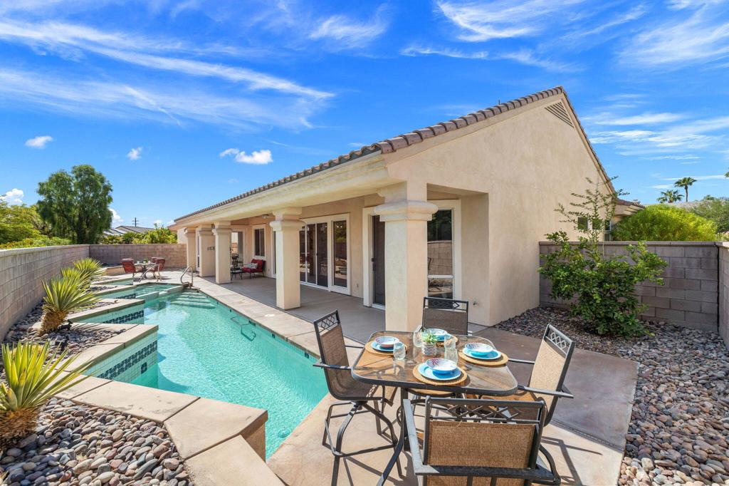 Located in the best 55+ community in the valley, Sun City Palm Desert, the Monaco is one of the most popular models. With 3 bedrooms, 3 baths, a formal living/dining room, and a family room open to the kitchen. It is perfect for entertaining. As you enter the tropical gated courtyard and into the home, you are awe-inspired by the sparkling lap pool/spa, and the extended north-facing backyard patio, perfect for afternoon BBQs. The upgraded kitchen has stainless appliances, white cabinets, a skylight, and it opens to the family room and kitchenette area. The master bedroom views the pool, and the ensuite bathroom has a double vanity, a private toilet room, a walk-in closet, a walk-in shower, and a soaking tub. The extended guest bedroom is huge, with its own ensuite bathroom, and can be used as an office, hobby room, or private guest bedroom. The extended den/bedroom has a full bathroom attached, and a beautiful built-in double office desk, and plenty of shelving. The laundry room has storage of cabinets, an extra fridge, and the washer and dryer are included. The extended garage has a golf cart garage, storage cabinets, and a NEWER HVAC unit. There are motorized shades in the living room, dining room and front door. This home is the perfect year-round retreat.