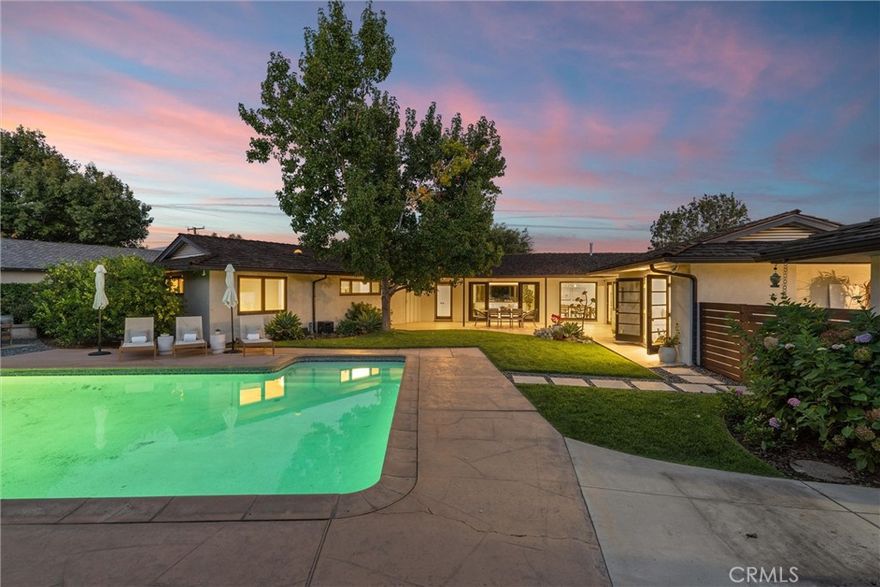 Set on a large, flat corner lot in the coveted San Gabriel Country Club neighborhood, this Mid-Century Ranch home is more than just a beautiful residence—it’s an exquisite retreat.

Originally designed in 1951 by William Plume, this single-level home has been thoughtfully reimagined and remodeled to embody the essence of California living. Gorgeous, rich hardwood floors flow throughout much of the home, while expansive windows and sliding glass doors bathe the interiors in natural light.

For those who love indoor-outdoor living, the layout is perfection—the living room seamlessly connects to the dining area, kitchen, and a wall of glass that opens to an inviting backyard oasis with a patio, pool, and lush gardens.

The updated kitchen is both stylish and functional, featuring a retractable Wolf range hood, built-in microwave/convection oven, center island, and a charming built-in banquette for casual dining.

A rear en-suite bedroom offers the ideal guest or in-law setup, complete with a Murphy bed and direct access to the pool area. The bedroom wing includes three spacious bedrooms and two full bathrooms, while a front corner room offers flexible use as an office, den, playroom, or additional bedroom.

Additional highlights include raised garden beds, 2 mature avocado trees, the most beautiful olive tree, citrus and apple trees, a covered back porch, and an oversized garage with modern frosted-glass doors that is wired for electric vehicle charging.

This rare San Marino-adjacent gem offers the ultimate California lifestyle and is truly a must-see.