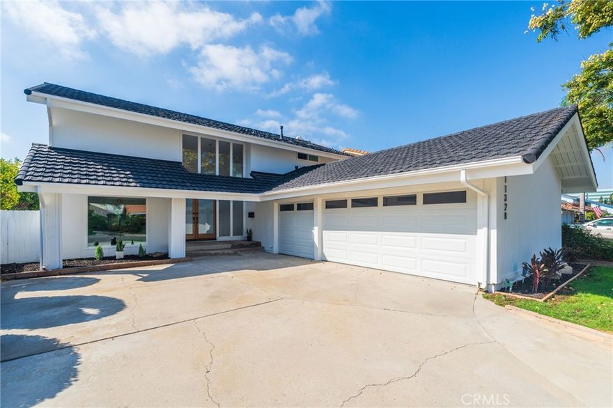 Welcome to this beautifully renovated home with a spacious 3-car garage, where modern design meets luxurious comfort. Located in a highly desirable neighborhood in Cerritos, CA. This stunning property boasts a spacious floor plan with four (4) generously sized bedrooms and various premium features that elevate your living experience. All 2.5 bathrooms have been tastefully renovated with modern mid-century touches. Step inside through a beautiful custom double wood door and be greeted by the inviting ambiance, enhanced by recessed lighting, new whisper white interior/exterior paint, all new windows, and premium laminate wood flooring throughout the home. The heart of this home is the chef-inspired kitchen, complete with gleaming quartz countertops, all-new stainless steel appliances, shaker-style slow-close cabinetry, and a custom peninsula with a waterfall finish perfect for both cooking and entertaining. There is a warm and inviting family room and a separate formal living room, which features a beautiful fireplace, providing a perfect setting for relaxing. This home offers a 3-car garage, providing ample storage or a space for a gym/hobby. Enjoy the private and cozy backyard to host all of your special gatherings. With its thoughtful design, premium finishes, and a fantastic layout, this home is the perfect blend of modern living and comfort. Great location with award-winning ABC school district, don't miss this chance to make this property your DREAM HOME!