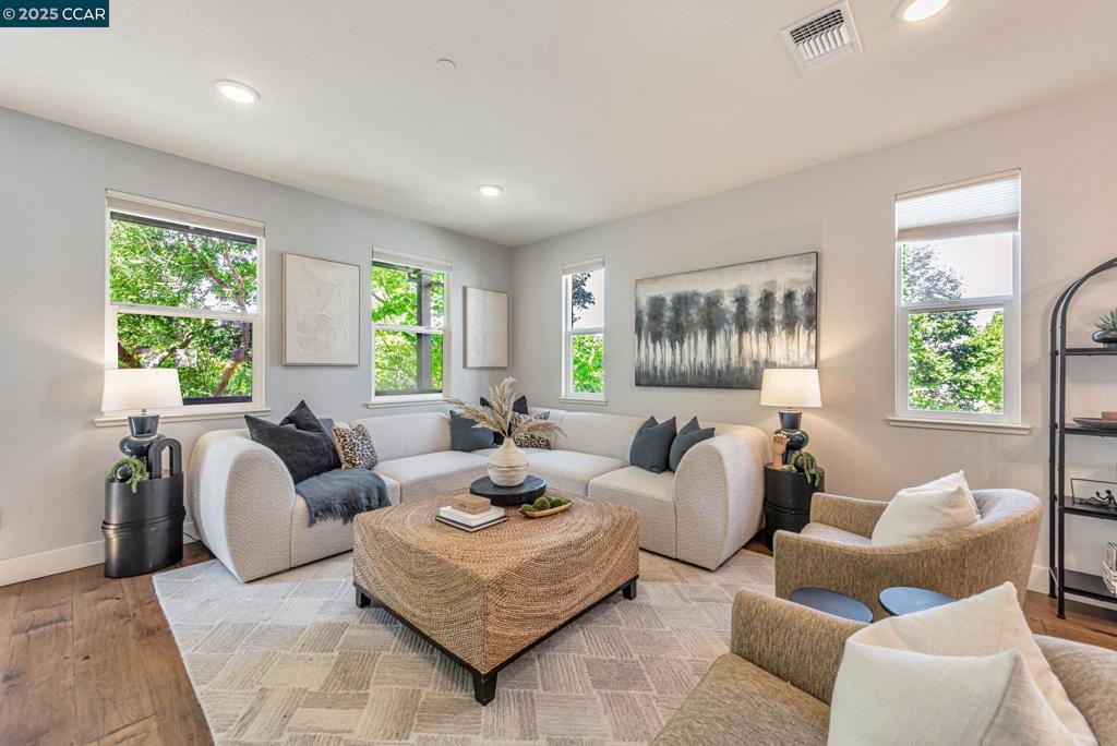 Welcome to the boutique Symmetry community - Alameda Landing. 467 Mitchell Ave is a rare, large 1937 sq. ft. corner-unit home boasting its own 3 private outdoor spaces, own garden, + 2 spacious decks! The modern 3-level home offers great livability, separation, and privacy. The first floor features a private bedroom with en-suite full bath and direct access to a rare backyard, ideal for guests, work-from-home, or multigenerational living. The second level is the heart of the home, with elevated ceilings, open-concept living, dining, and gourmet kitchen with oversized quartz island, abundant storage, and dedicated pantry that flow seamlessly to two serene outdoor decks, perfect for dining, entertaining, or relaxing. Upstairs, dual spacious primary suites, each with its own full bathroom for comfort and convenience provides rest. Steps from the Estuary, this locale combines the ease of urban living with waterfront charm, placing you close to shopping, dining, and outdoor recreation. Need more space? At the end of a court, a serene private park awaits. Commuting is simple with nearby SF Ferry, BART, Caltrain, and freeway access, making San Francisco and Oakland minutes away. A rare opportunity to enjoy both community and convenience in one of Alameda’s best neighborhoods