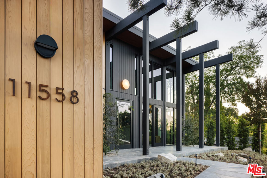 This period perfect FRYMAN CANYON 5 bed, 5 bath, MID-CENTURY POST AND BEAM renovation embodies the ethos of its time by staying true to its CLEAN LINES and careful simplicity with thoughtful re-imagining to cater to today's MODERN LIVING AND ENTERTAINING. This three year renovation was designed and carefully sourced by a high end design group with absolutely NO EXPENSE SPARED. This DWELL FEATURED home has floor to ceiling WALLS OF GLASS in an awe-inspiring living room with 20 FT. CEILINGS, complemented by a massive TWO-STORY MATTE BLACK GAS AND WOOD BURNING FIREPLACE and stunning slate floors that seamlessly extend to the outdoors, FUSING THE INDOOR AND OUTDOOR SPACE with ease. Experience a DEEP CONNECTION TO NATURE through multiple walls of glass, opening to WONDERFUL OUTDOOR SPACES showcasing EARTH, WATER AND FIRE ELEMENTS, with a new PEBBLE-TEC SALT WATER POOL/SPA, gas fire pit sitting area, WOOD DECK and PICTURESQUE MATURE LANDSCAPING, including JAPANESE MAPLE trees and blooming MAGNOLIAS providing complete privacy. An expansive GOURMET KITCHEN has a 25 FOOT QUARTZITE ISLAND, with MIELE appliances, and an island of slatted custom white-oak mill work cabinetry designed and CUSTOM MADE for the space. Slatted wood design accents grace the stunning staircase to the upstairs loft and bedrooms. WHITE OAK wide plank floors span the upstairs space, where ALL UPSTAIRS BEDROOMS ARE EN-SUITE, with bathrooms featured in HOUSE BEAUTIFUL and various other publications. The large primary suite has a balcony and mountain views, with a ROOM SIZED DRESSING ROOM with 8 custom-built OAK WARDROBE CLOSETS with additional built-in drawers offering plentiful enclosed wardrobe and shoe storage. The primary bathroom has a custom made dual vanity, Quartzite counters, TERRAZO FLOORS and a large walk-in shower and separate soaking tub. AUTOMATIC BLINDS ON REMOTES in most rooms allow light or privacy instantly. FULL SECURITY SYSTEM with cameras. TWO LAUNDRY ROOMS, one on each level. There are simply not enough words to describe this BREATHTAKING and emotional home. Furnishings are a fusion of restored Danish/European MCM imports and new Modern. If your clients are looking for an ULTRA-SEXY renovated lease that is NOT your cookie-cutter new construction, THIS IS IT. Just a couple blocks to serene HIKING TRAILS and close to all the studios, with easy access to Beverly Hills and Hollywood and top rated Carpenter School District. This VISUALLY CAPTIVATING home is UNRIVALED in today's rental market!
