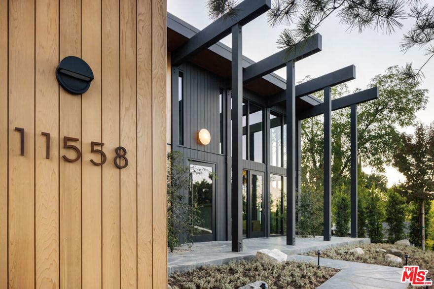 This period perfect FRYMAN CANYON 5 bed, 5 bath, MID-CENTURY POST AND BEAM renovation embodies the ethos of its time by staying true to its CLEAN LINES and careful simplicity with thoughtful re-imagining to cater to today's MODERN LIVING AND ENTERTAINING.  This three year renovation was designed and carefully sourced by a high end design group with absolutely NO EXPENSE SPARED. This DWELL FEATURED home has floor to ceiling WALLS OF GLASS in an awe-inspiring living room with 20 FT. CEILINGS, complemented by a massive TWO-STORY MATTE BLACK GAS AND WOOD BURNING FIREPLACE and stunning slate floors that seamlessly extend to the outdoors, FUSING THE INDOOR AND OUTDOOR SPACE with ease.  Experience a DEEP CONNECTION TO NATURE through multiple walls of glass, opening to WONDERFUL OUTDOOR SPACES showcasing EARTH, WATER AND FIRE ELEMENTS, with a new PEBBLE-TEC SALT WATER POOL/SPA, gas fire pit sitting area, WOOD DECK and PICTURESQUE MATURE LANDSCAPING, including JAPANESE MAPLE trees and blooming MAGNOLIAS providing complete privacy. An expansive GOURMET KITCHEN has a 25 FOOT QUARTZITE ISLAND, with MIELE appliances, and an island of slatted custom white-oak mill work cabinetry designed and CUSTOM MADE for the space.  Slatted wood design accents grace the stunning staircase to the upstairs loft and bedrooms.  WHITE OAK wide plank floors span the upstairs space, where ALL UPSTAIRS BEDROOMS ARE EN-SUITE, with bathrooms featured in HOUSE BEAUTIFUL and various other publications.  The large primary suite has a balcony and mountain views, with a ROOM SIZED DRESSING ROOM with 8 custom-built OAK WARDROBE CLOSETS with additional built-in drawers offering plentiful enclosed wardrobe and shoe storage.  The primary bathroom has a custom made dual vanity, Quartzite counters, TERRAZO FLOORS and a large walk-in shower and separate soaking tub.  AUTOMATIC BLINDS ON REMOTES in most rooms allow light or privacy instantly.  FULL SECURITY SYSTEM with cameras.  TWO LAUNDRY ROOMS, one on each level. There are simply not enough words to describe this BREATHTAKING and emotional home. Furnishings are a fusion of restored Danish/European MCM imports and new Modern.  If your clients are looking for an ULTRA-SEXY renovated lease that is NOT your cookie-cutter new construction, THIS IS IT.  Just a couple blocks to serene HIKING TRAILS and close to all the studios, with easy access to Beverly Hills and Hollywood and top rated Carpenter School District. This VISUALLY CAPTIVATING home is UNRIVALED in today's rental market!