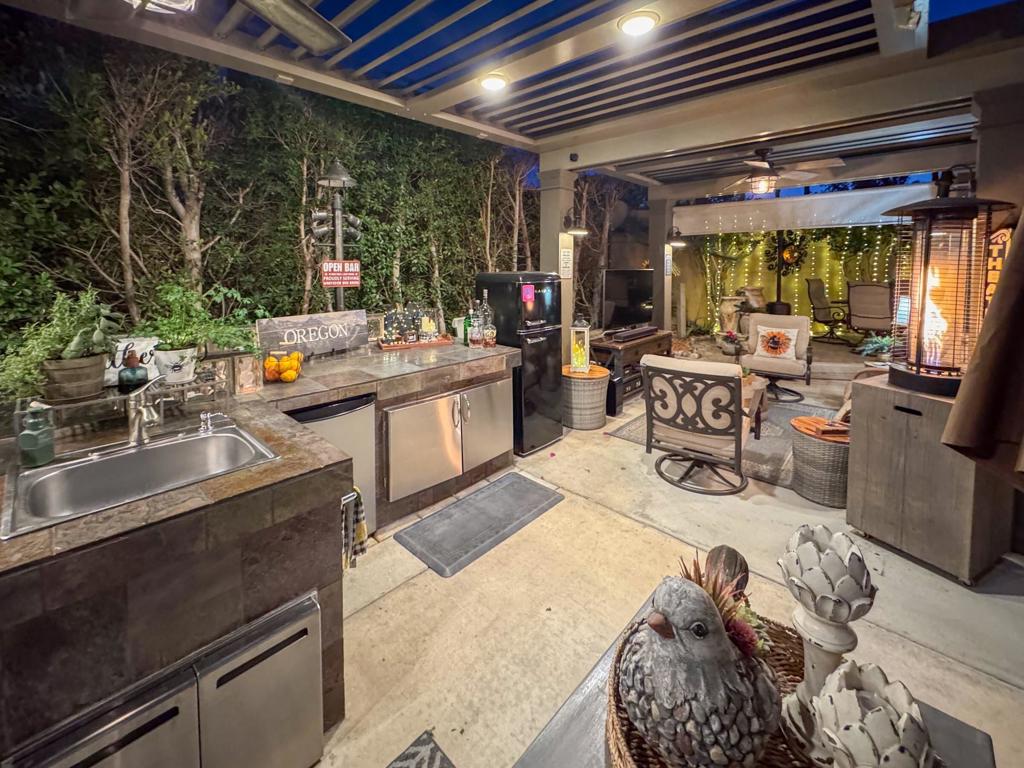 Escape to your private oasis under a stunning Equinox pergola with solar-powered louvers that open to let in the night sky or close to shield you from the sun--all at the touch of a button. Perfect for entertaining, this property offers breathtaking mountain views and is conveniently located near a premier golf course. Whether you're hosting friends or enjoying a quiet evening, the living areas are designed for comfort and style. The pergola features two ceiling fans to keep you cool, and its proximity to the perimeter pool, sauna, and hot tub adds a touch of resort-style luxury. The property is also close to laundry facilities, making life even more convenient.Inside, you'll find a fully equipped kitchen with a stove, oven, BBQ grill, roll-around island, dishwasher, sink, storage cabinets, and a fridge, along with all the dishes, pots, pans, and silverware you'll ever need. The cozy living area boasts two swivel chairs, two leather recliners, a 55' smart TV, and stylish end tables. Outdoor living is equally impressive, with a fire pit area complete with a loveseat and swivel rockers, a rear dining area with a table and swivel chairs, and a bar area with an under-counter fridge. Additional features include three roll-down blinds, a serene water feature, flower pots, four storage containers, umbrellas, and even two landscaped areas your pet will love. The beautifully landscaped front and back yards are ready for you to enjoy, and it comes furnished. The motorhome is for sale separately. A golf cart is also negotiable, making this property a complete dream for those seeking relaxation, convenience, and entertainment.‍Outdoor Resort Indio is a Class A only resort in Indio, CA.