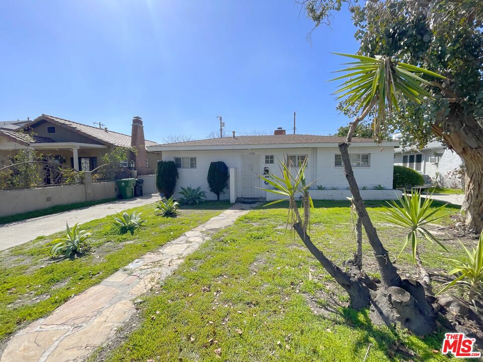 Experience the charm of this rustic and spacious ranch-style home in the vibrant NoHo Arts District! This 2BR/1BA home (approx. 911 sq ft) blends character and comfort with Spanish tile flooring throughout, a well-appointed kitchen with dishwasher, in-home washer/dryer, and wall A/C units in each bedroom for personalized comfort. Cozy up in the living room, complete with a charming wood-burning fireplace perfect for relaxing evenings or entertaining guests. The property boasts a 2-car garage with a long driveway for ample parking, plus a huge private backyardgreat for entertaining, gardening, or relaxing in total privacy. Tucked away in a peaceful setting yet just moments from the NoHo West shopping center, theaters, dining, and nightlife, this home offers the perfect balance of tranquility and city living. Pets welcome.