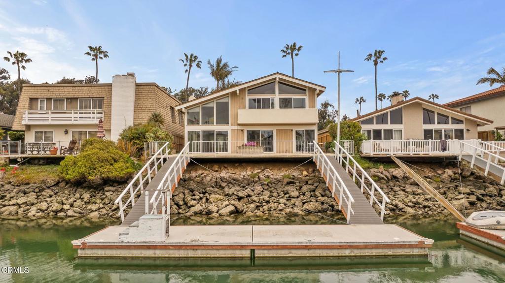 Welcome to this serene Ventura Keys home, a perfect retreat for coastal living in the sought-after Ventura Keys neighborhood. This inviting residence features 5 bedrooms, 3 bathrooms, and a 3-car garage. Large windows fill the space with soft natural light and offer tranquil views of the waterways. The primary suite is a peaceful haven with direct outdoor access, while the four additional bedrooms provide flexibility for guests, an office, or hobbies. The backyard includes a quiet patio and a private boat dock, ideal for boating or relaxing by the water with stunning views. Inside, enjoy a cozy fireplace, recessed lighting, hardwood floors, and a 40ft boat dock. Located in Ventura Keys, you're steps from the beach, shops, dining, and amenities.