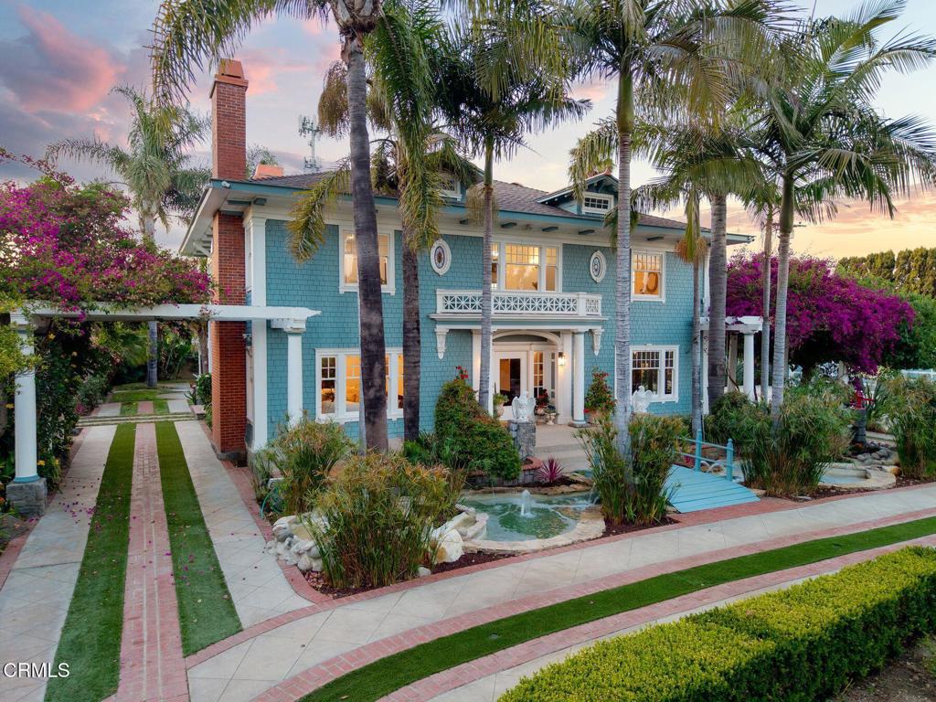 Welcome to Palm & Proper -- a rare Ventura estate where timeless craftsmanship meets modern luxury. Originally built in the 1920s and thoughtfully restored, this Hamptons-inspired home blends historic character with curated, high-end finishes throughout.The heart of the property is a stunning pool courtyard flanked by the main residence and two charming guest houses, creating a private, social retreat ideal for gathering, relaxing, or entertaining in style.Inside the main home, every detail has been elevated -- from the classic millwork and marble finishes to the custom kitchen, butler's pantry with copper sink, bespoke wetbar and lounge and sophistication of a hidden wine cellar. Each room feels both fresh and rooted in history.Step beyond the Craftsman charm and into a private paradise--Palm & Proper's lush, gated grounds are a showpiece in their own right. Wander through blooming bougainvillea, tranquil koi ponds, and bubbling fountains that set the tone for resort-style living. The sparkling pool, outdoor shower, and hidden grotto invite pure relaxation, while the built-in BBQ, fire pit, and multiple al fresco dining spaces make entertaining effortless. Several raised garden beds--set apart among mature fruit trees--offer a true farm-to-table experience. Even the practical elements are artfully integrated, with garages and ample parking tucked away, and carports cleverly hidden behind flowering bougainvillea.Framed by stately palms and ideally situated for refined ease of travel and connectivity, this estate is a true nod to the beauty of Ventura's landscape and idyllic climate. It's a place where sophistication and coastal lifestyle effortlessly meet.