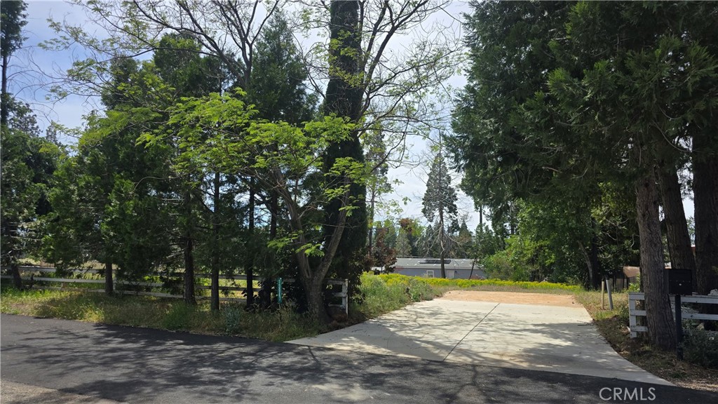 AN IDEAL & LEVEL .23-ACRE LOT!! This level property is level and ready for your dream home with an existing septic system (unknown condition), plus power & water at property just waiting to reconnect to your new home! Beauty surrounds this property as it is close to the disk golf course with paved walking trails and the beautiful green space at the Magalia Community Park down the street. There is also abundant wildlife such as dear and wild turkey sharing the open space around the neighborhood. It offers great development potential, with a driveway already in place as well as a front fence & existing trees framing the front yard. The neighborhood boasts a mix of new and established homes, lending it that unique mountain charm. Moreover, the property is conveniently located less than a mile away from a grocery store, various shopping options, the post office, and dining establishments. It also offers a quick and easy commute via Skyway to both Paradise and Chico. For outdoor enthusiasts, this lot is a short drive from recreational opportunities such as fishing, water sports, and adventure in Paradise Lake, DeSabla Lake, Lake Oroville Marina, or the Feather River. The property's inclusion in the Paradise Pines Property Owners Association enhances its appeal & charm, offering access to amenities such as pickleball and bocce ball courts, a children's playground, hiking trails, a swimming pool and spa, a clubhouse with meeting rooms and a library, dual event centers with fully equipped kitchens, and a bar and lounge for special events and community gatherings. This lot represents the opportunity you've been seeking!