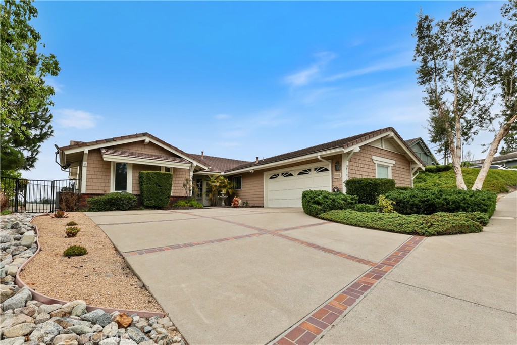 Highly sought after Sky Gate community. This single story, one owner, home boasts spectacular panoramic views of north east Orange County. New expertly installed quality flooring. Fresh interior paint. Brand new kitchen appliances. This home is perfect for entertaining. Extra large primary bedroom with views from large sliding glass door and windows. The primary bedroom has a nook large enough to mount a 80+ inch flat screen television. The primary bedroom has both closet generous walk in closet. The primary bedroom's bathroom has a dual vanity large bathtub and separate walk-in shower. Low maintenance landscaping (no grass). What makes Sky Gate homes special is the unique architecture. There are dual, 2 sided, wood/gas burning fireplaces. One of the bedrooms has an adjoining bathroom access door. In the center of the home there is a lavish enclosed wet bar. Formal dining room with separate dining area in the kitchen. This is not a typical track home. There are only 40 homes built by this builder in the community. The last 2 recent sales in this community (Sky Gate) sold above list price with multiple offers. Don't miss this one... It is truly special.