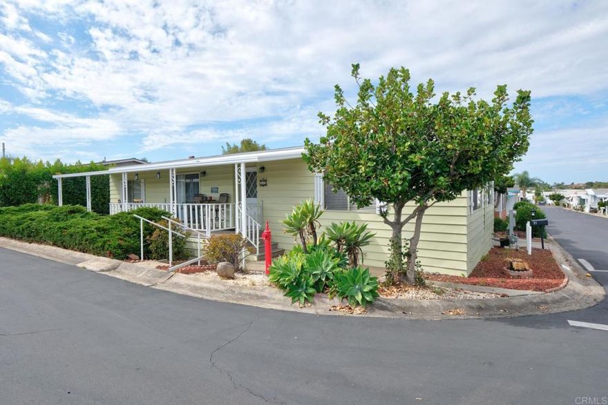 Welcome to Your Slice of SoCal Paradise! Location, Location, Location Contact Listing Agent Sean Shearier 760 522 5377  ABSOLUTELY in pristine condition! Extensively remodeled!!  This front and center corner lot is nestled in the vibrant Vista Royal Lodge 55+ community, this charming 2-bedroom, 2-bath home at Space 51 is packed with personality, natural light, and comfort — all at an incredible value you wont find elsewhere in North County! Whether you're looking to downsize, simplify, or just soak up the sunshine, this home checks all the boxes. Many improvements have been made to this beautiful home by the current Seller, so much that you would think it was newer than a 1975: textured walls and ceilings, 4 1/2" baseboards, rounded corners, interior and exterior painting, all NEW kitchen appliances that includes a combination washer/dryer "hidden" behind a curtain in laundry area off kitchen, granite counter tops, hardwood floor in kitchen and breakfast/laundry area, neutral color carpet, Basswood wooden blinds with matching wood window sills and trim around windows, upgraded light fixtures, mirror closet doors in Bedroom #2 and Master Bedroom and shower replacement in Master Bath.  There are "two (2)" sheds offering ample storage, full length covered carport, and low maintenance yard yet large enough for gardening if you so choose. This home offers beautifully simulated wood floors and a brand new HVAC system for ultimate comfort.  Step inside to find vaulted ceilings, an open-concept living area, and large windows that let the coastal breeze flow right through. The spacious kitchen offers plenty of storage, counter space, and a breakfast bar perfect for morning coffee or entertaining friends.  Enjoy two generously sized bedrooms — including a primary suite with a private bath — plus a bonus sunroom or office space that adds flexibility to your lifestyle. Outside, relax on your covered patio, plant a little garden, or just enjoy the peace and quiet under the swaying palm trees.   Community perks? Oh yes! You'll love the resort-style pool & spa, clubhouse events, and friendly neighbors that make this all-age-at-heart community feel like family.   Conveniently located near shopping, dining, medical centers, and just a short drive to Carlsbad beaches, you're never far from fun in the sun.   Low space rent | Pet-friendly | Affordable SoCal living!  Schedule a showing today! Message Sean for the combo.