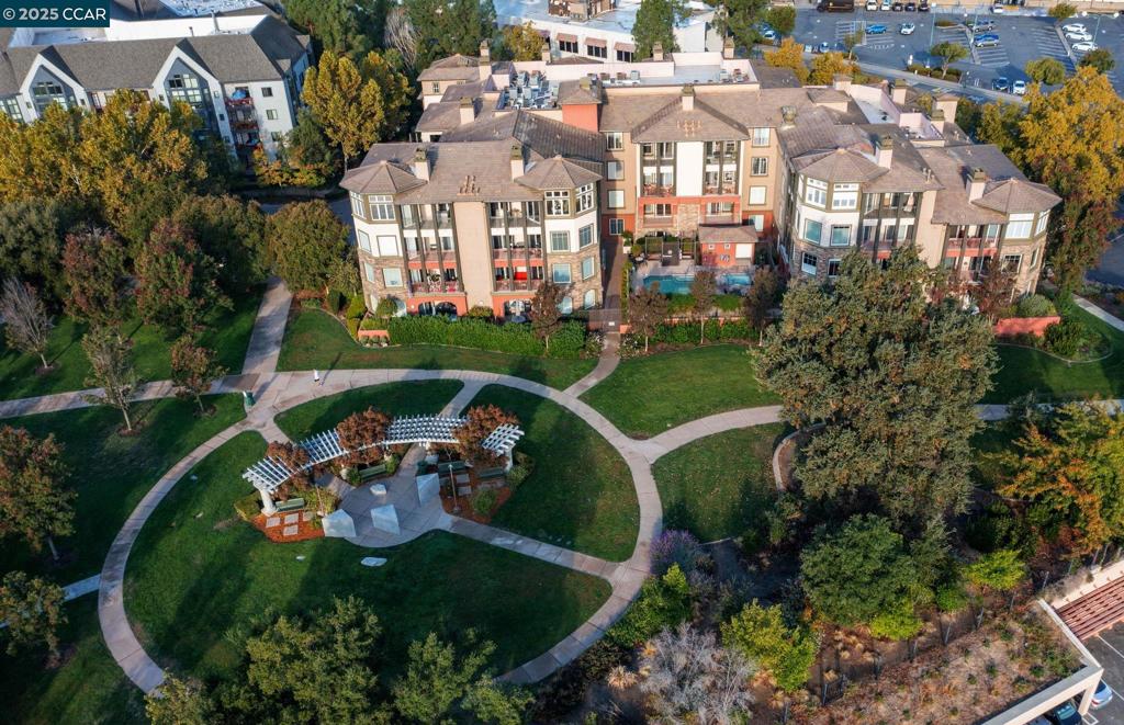 Discover luxury living at Regent on the Park, an upscale boutique condominium building in downtown Walnut Creek. This ground-floor unit features an open-concept design with a spacious living room, bonus office that can function as a 3rd bedroom, and gas fireplace. The modern, updated kitchen anchors the main living space, boasting stainless steel appliances and white cabinets. The primary suite offers a peaceful retreat with walk-in closet, and ensuite bathroom with double sinks and soaking tub. A second bedroom, full hall bath, and in-unit washer/dryer complete the layout. Remote control blinds, crown molding, new H2O heater and A/C. Private patio flows onto common space to play with the dog, set-up corn-hole, entertain. Building Amenities: Pool, spa, fitness center, game room. Parking: Two assigned spaces, storage and 2 private EV chargers in secure underground garage. Nestled next to Alma Park in downtown, walk to Broadway Plaza, restaurants, shopping, and top-rated schools. 2 blocks to highways 24 and 680. Excellent schools, including Las Lomas High School. Experience the perfect blend of luxury and convenience in Walnut Creek's most desirable address, along with a wonderful, on-site property manager.