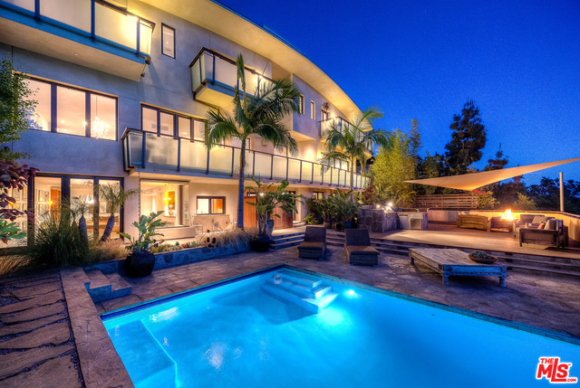 Resort-style living at its finest. Luxurious architectural gem meticulously designed by Phillip Vertoch, takes advantage of mesmerizing mountain and blue water ocean views. Set on a lush hillside in the upper Riviera, one is encompassed by the peacefulness and beauty of the spectacular landscape. Highlights of this home include big wall space for art, high ceilings and gleaming hardwood throughout, theater/screening room, wine cellar, paddle tennis/sports court, organic garden area and terraced hillside vineyard. Spacious outdoor area with teak deck, infinity pool/spa and fire pit perfect for entertaining. Bedrooms feature en-suite bathrooms and private decks. Captivating master with ocean view balcony, fireplace, and grand outfitted walk-in closet. Beautiful open living spaces and stunning cook's kitchen with over-sized butler's pantry and family lounge area. Second living/game room with bar area that opens to yard and infinity pool for ultimate indoor/outdoor California living.