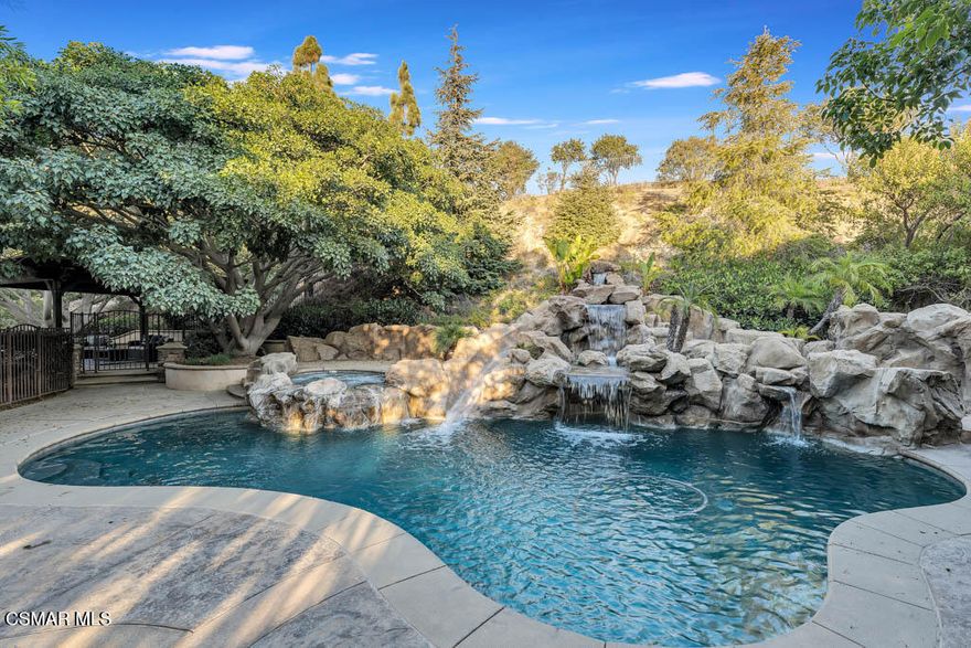 Enjoy Absolute Peace & Serenity in your own private Resort Style Dos Vientos Residence! Over 4,000 sq.ft. at the end of cul de sac on a 20,000+ square foot lot with the most amazing private yard backing open space. Magical Pool w/ cascading waterfalls, spa & WATERSLIDE. Enjoy Entertaining large gatherings with the enormous covered pavilion that fits a spacious dining table plus sitting area; Patio with Outdoor Fireplace and Grassy area. Immaculate 5 bedroom home with recently installed wide plank wood-like flooring throughout. Entertaining is a dream with the formal Living Room & Formal Dining Room adjacent to the Spacious Great Room featuring Gourmet Kitchen with Large Center Island, Granite Counters, Stainless Steel appliances, large eating area open to Huge Lounging Area with Fireplace/Entertainment Center.  Primary Suite w/ Library Retreat, Fireplace, Office Nook, Jetted Tub, Separate Vanities, Organized Walk-In Closet. Crown Molding, Plantation Shutters, and so much more! One Bedroom & Bath Downstairs. Downstairs Bedroom does not have a closet. Enjoy epoxy floors in large garage. Separate hidden third car garage for additional storage. Fall in Love Here! This is a one of a kind Dos Vientos home. Do not miss this opportunity! Enjoy fabulous parks, tennis, playgrounds, hiking trails and the best schools all just steps away.
