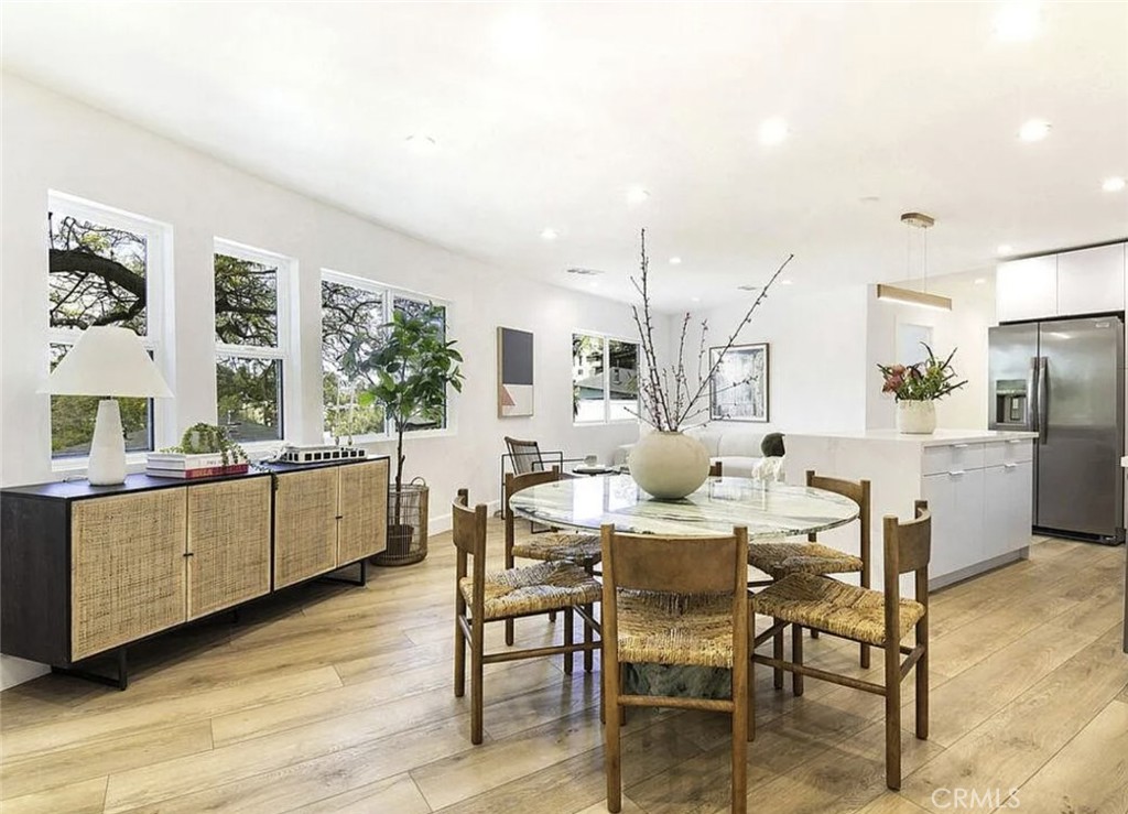 This side-by-side, townhouse-style duplex in prime Silver Lake features striking architectural design, with the exterior walls following the curve of the hillside street. Surrounded by mature trees and offering views from every level, each unit includes private balconies. Unit 1428 opens to a spacious, open-concept kitchen, living, and dining area. The kitchen includes a center island with breakfast bar, new stainless steel appliances—refrigerator, range/oven, dishwasher, and built-in microwave—and quartz countertops. The first floor also offers one bedroom, one bathroom, in-unit laundry, and a porch off the kitchen for outdoor dining. Upstairs are two additional bedrooms and two full bathrooms, including a primary suite. A highlight of the home is the oversized upstairs porch, offering privacy among the treetops with views of Griffith Observatory and Griffith Park in one direction, and the Downtown Los Angeles skyline in the other. The home has been recently remodeled with commercial-grade waterproof vinyl wood flooring, new insulation in all walls (including premium soundproofing in the shared wall), Level 5 smooth-finish drywall, Lutron smart lighting, central air conditioning, and recessed lighting throughout.