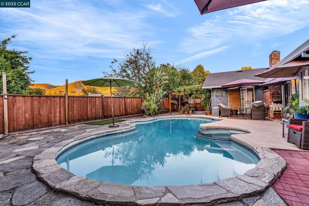 Best deal on the market for a 4-bedroom in all of Concord! Situated on a quiet cul-de-sac, in the sought after Kirkwood neighborhood, this gem awaits your vision. Fall in-love with the entertainer’s dream yard with a newly resurfaced sparkling pool, inviting seating area, and lush gardens, all framed by treetop views and distant hills. The kitchen opens to the family room and flows seamlessly to the private yard, perfect for hosting and outdoor living. Recent improvements include a new electrical panel, new fence, stainless steel appliances, granite countertops, French drain, custom window shutters, new vinyl sliding patio doors with built-in shades, upgraded pool equipment, gas fireplace, and ceiling fans. The seller has cherished this home for years and is ready for new owners to make it their own. Tackle the cosmetic TLC needed and watch your equity soar.