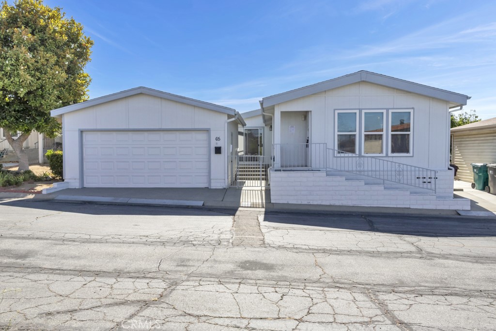 Welcome to this beautifully maintained, freshly painted 2-bedroom, 2-bathroom home located in the highly desirable 55+ Banning Estates (where you own the land!! )Manufactured Home Community in Banning, CA. Built in 1984, this spacious residence offers 1,490 square feet of thoughtfully designed living space on a 3,920 sq ft lot, with an open floor plan and abundant natural light throughout. The home features generously sized bedrooms and large bathrooms. You'll also find desirable Corian countertops, a bar area perfect for entertaining, and an electric fireplace for added comfort. Custom wallpaper adds charm and character, while built-in storage and ample cabinetry throughout the home provide plenty of functionality. The convenience of an indoor laundry room makes daily living even easier. A detached 2-car garage offers additional storage and secure parking. Set within a peaceful and well-maintained 55+ community, residents enjoy access to a variety of amenities designed for active adult living an SUPER LOW HOA fees! Don't let this one slip away!! This is a wonderful opportunity to enjoy comfort, space, and lifestyle in one of Banning’s most welcoming neighborhoods.