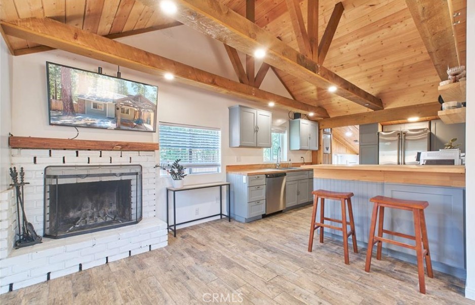 Upgraded cottage a block from lake access. The entire interior was recently remodled with perfect blend of modern feel with rustic touch. Light and bright open floor plan with open beam vaulted ceilings and cozy fireplace. Beautiful Kitchen w/ butcher block countertops and breakfast bar. Stainless steel appliances. Tiled shower/tub with glass doors. Property is fenced with wood privacy fence. plenty of flat parking and a large storage shed. Detached garage was converted to a workshop office and it's own bathroom. Close to everything, the lake, the Village, Snow Summit and Bear Mountain Ski Resorts and hiking trails. This property is perfect starter home, short term rental or mountain retreat.