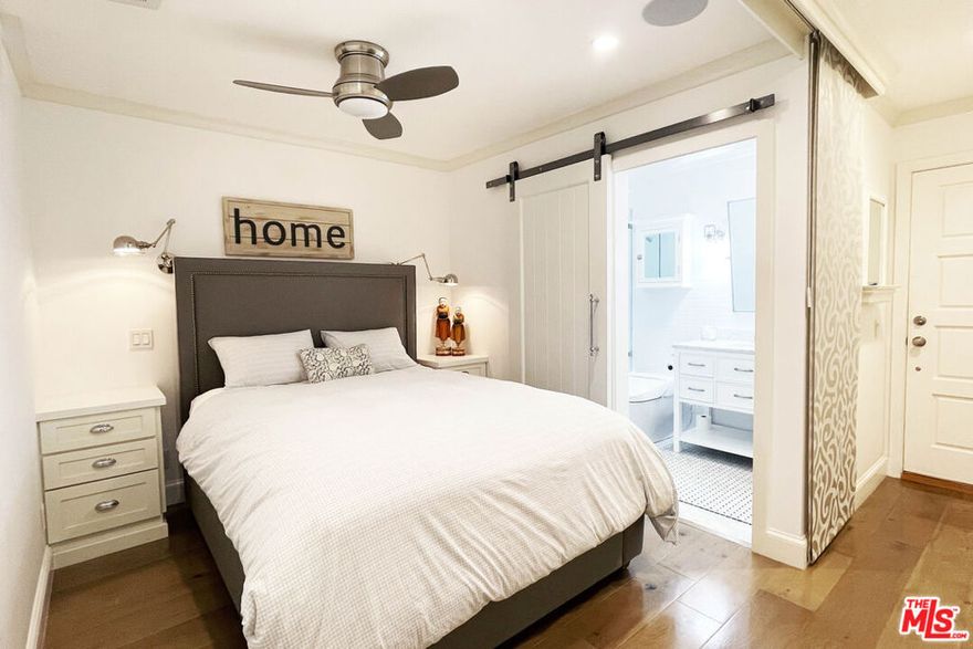 Drive down a palm lined Santa Monica beach street, breathe the ocean air, and arrive at a polished modern farmhouse inspired retreat designed for effortless living. Inside, a serene private sleeping suite offers the comfort and function of a true bedroom, while thoughtful upgrades like a smart bidet, in-unit laundry tucked into a walk-in cedar closet, and a chef's kitchen with fully integrated appliances elevate everyday comfort. Two panel-ready refrigerators, a built-in freezer, a concealed dishwasher, and a hidden pull-out disposal compartment vanish behind custom cabinetry for a refined, furniture quality finish. Sunlight fills the space through patio doors, linking the open living and kitchen areas to easy mornings and spontaneous evenings out. Quietly set as the final residence at the back of the building, it features both a welcoming front entrance and a discreet direct to garage exit, with secure parking just steps from your door for seamless comings and goings. A stone's throw from Montana Avenue and moments from the beach, this turnkey hideaway makes settling into Los Angeles feel immediate. This is truly the best value in all of Santa Monica.