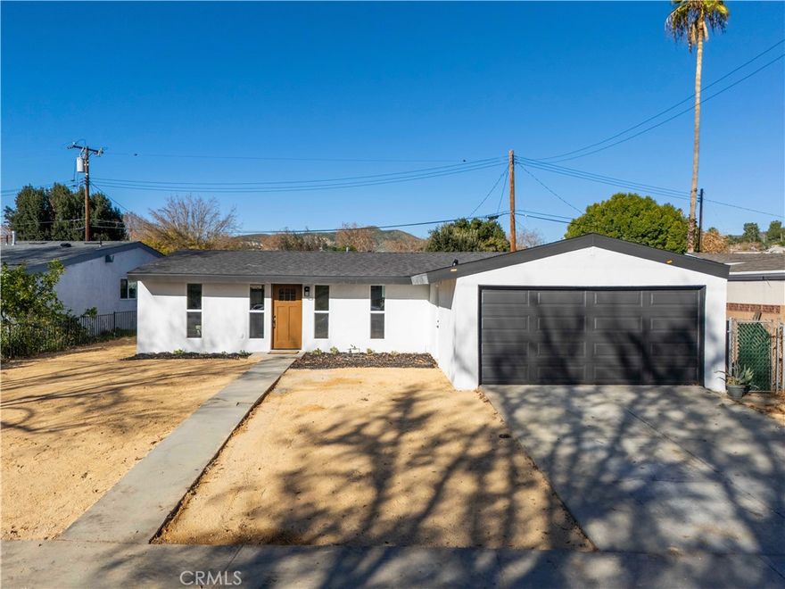 Built for moments like this. Welcome to your fully reimagined Santa Clarita MVP home. This isn’t just a remodel — it’s a complete transformation. Thoughtfully redesigned, this home delivers peace of mind, modern style, and endless upside for today’s lifestyle. From the outside in, everything has been upgraded. Enjoy a brand-new roof with warranty, new stucco, new fascia boards, new exterior doors, a new garage door, and fresh, easy-to-maintain landscaping that sets the tone the moment you arrive. Inside, it’s a true turnkey experience. The home features all-new drywall, Romex wiring, electrical panel, insulation, furnace, HVAC, and energy-efficient windows with a 25-year warranty. Waterproof LVP flooring flows throughout, paired with all-new interior doors and sleek recessed lighting for a clean, elevated look. The heart of the home is the entertainment-style kitchen, designed for real living and hosting. Quartz countertops, gold hardware, expanded cabinetry, and a sink facing the backyard create the perfect blend of function and style. A brand-new bathroom with designer tile and modern vanities completes the interior, along with a newly added indoor washer and dryer for everyday convenience. Step outside to a large, entertainment-ready backyard — pool-size, ADU-potential, and already equipped with added storm drains. Whether you’re hosting friends, building an ADU, or creating your dream outdoor space, this yard is a true blank canvas. Additional upgrades include a new gas main and regulator, a recently inspected and clean sewer line, and systems designed to give you confidence for years to come. Turnkey. Upgraded. Built to last. This is Santa Clarita living — the MVP way.